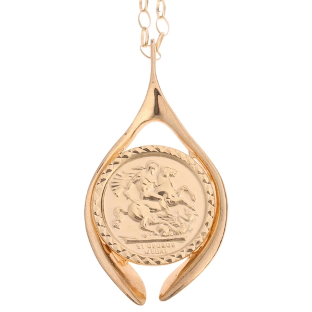 A Vintage 9ct gold St George medal wishbone pendant necklace...