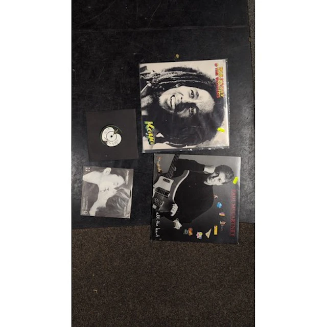 A group of vinyl records and sleeves: Bob Marley & the Waile...