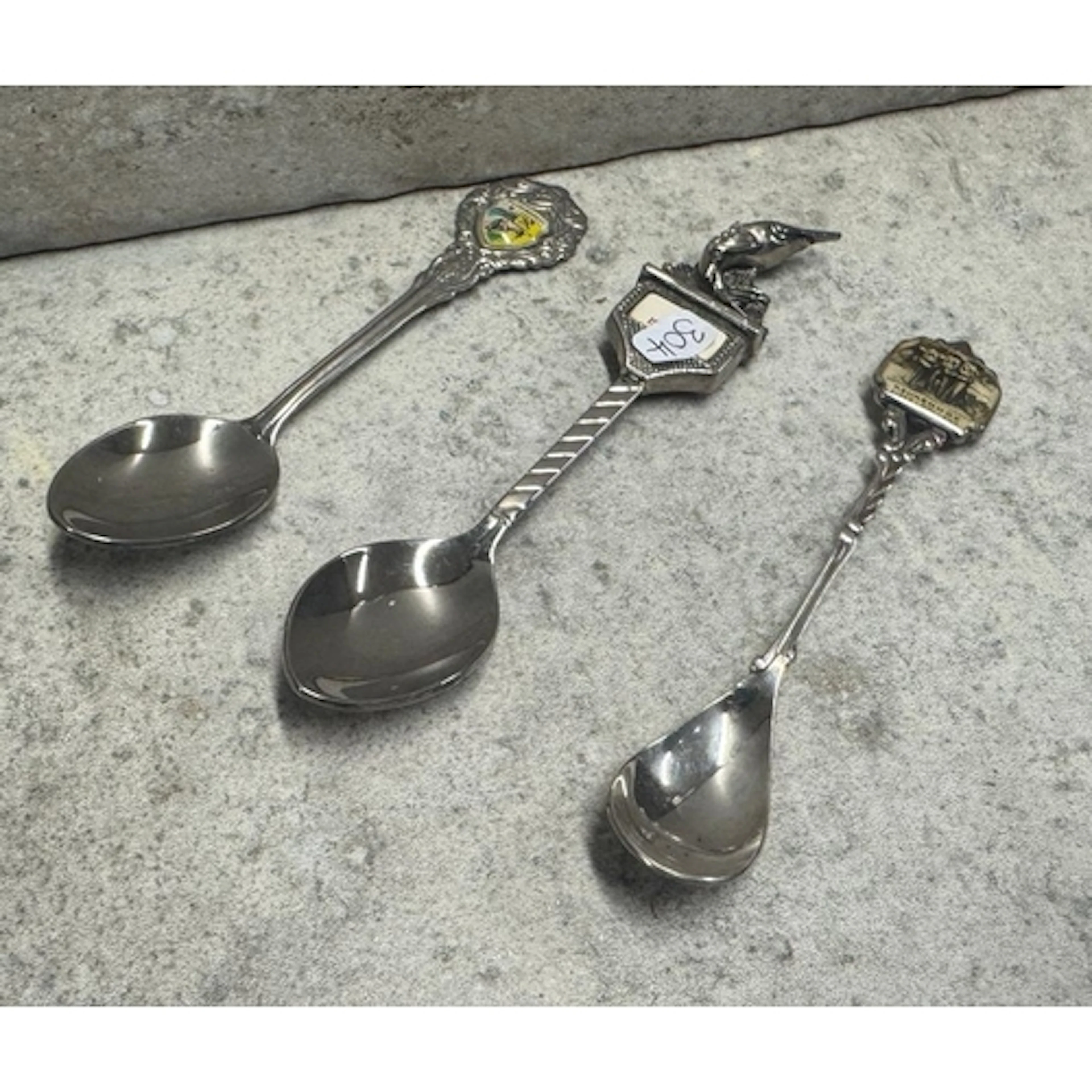 Three silver-plated souvenir spoons. Est. £10 - £15.