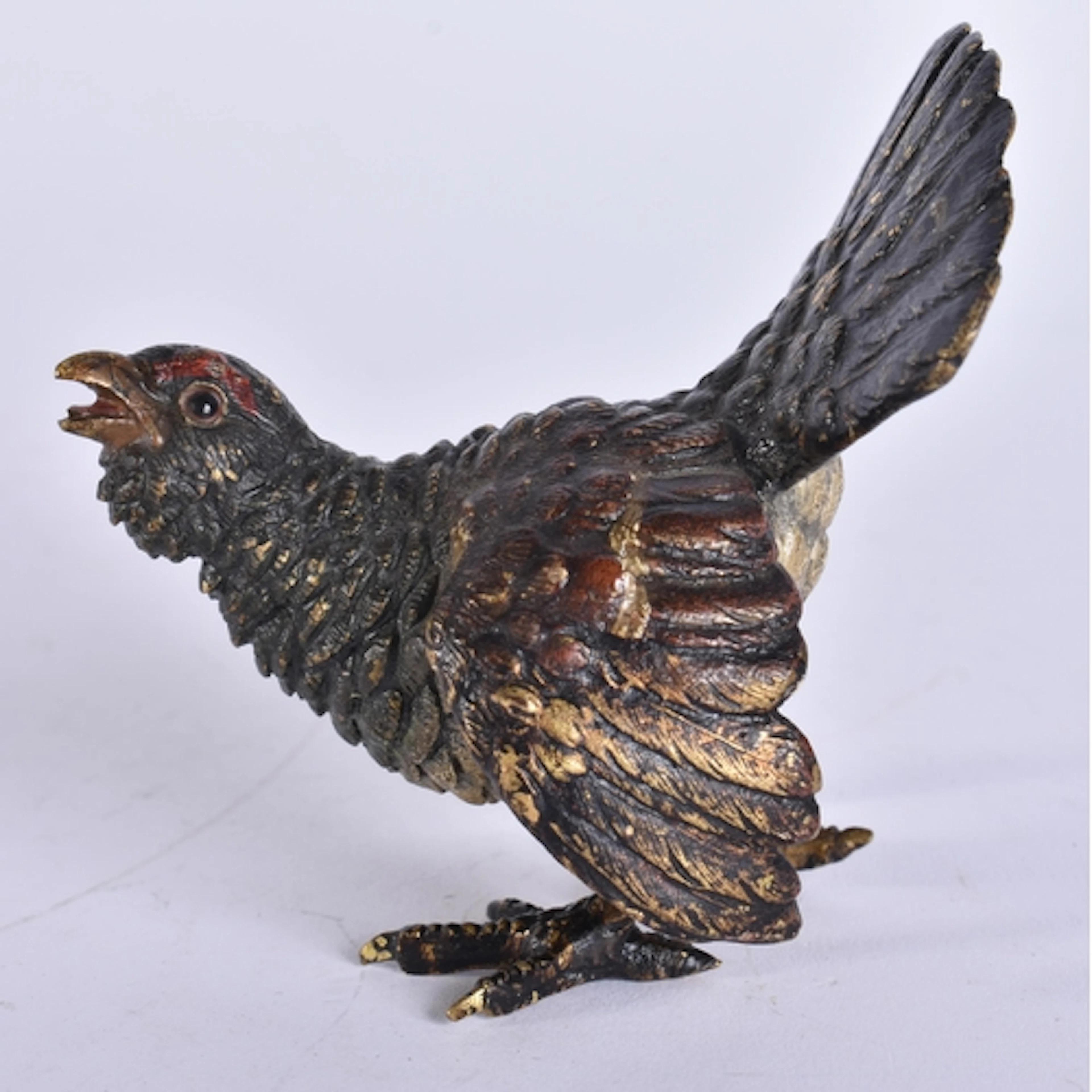 AN ANTIQUE COLD PAINTED BRONZE GAME BIRD. 9.5 cm x 5.5 cm.