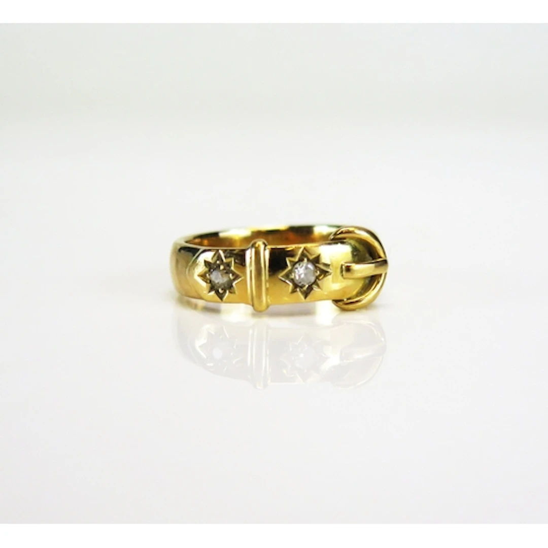 A Victorian buckle ring set with two European cut diamonds i...