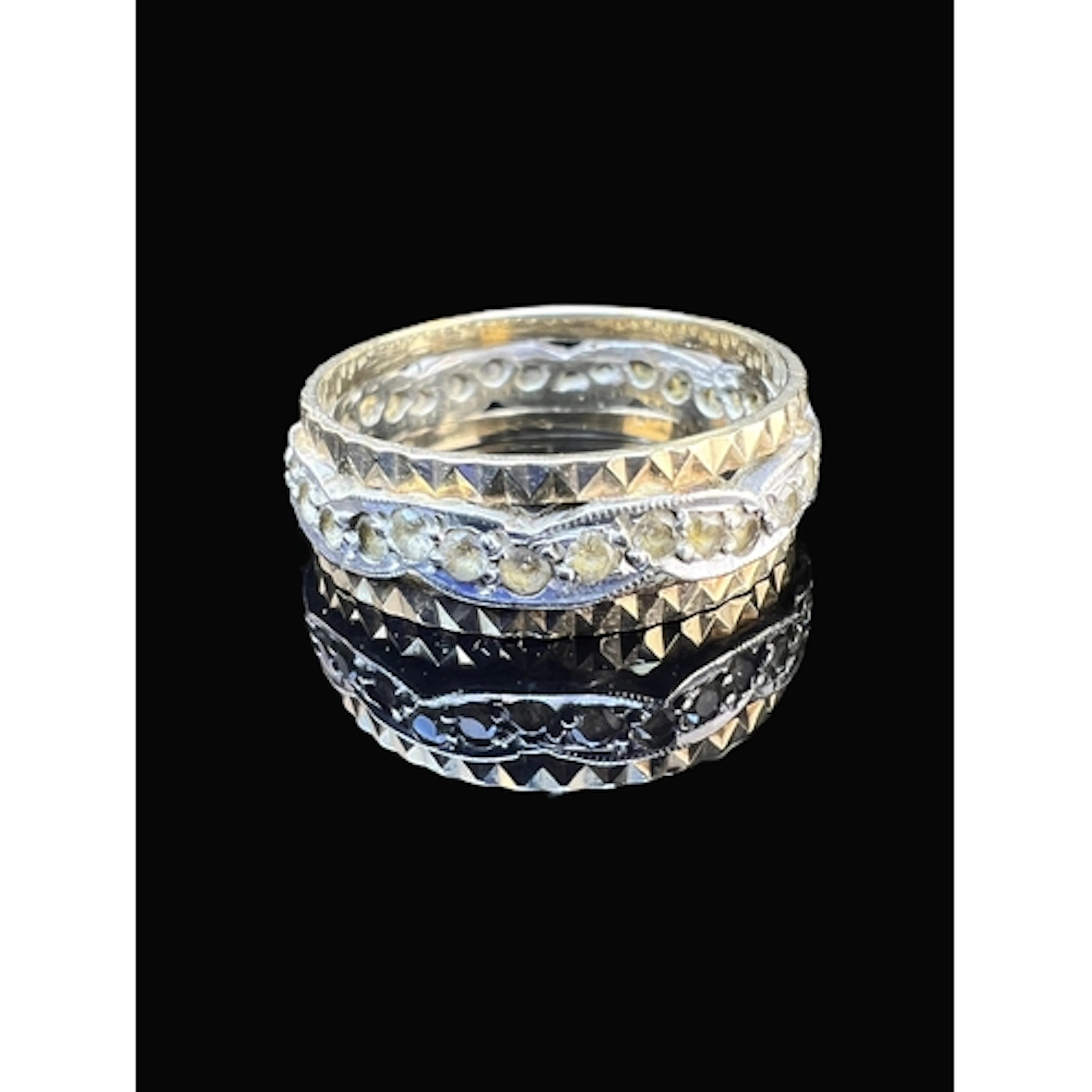 A yellow and white metal eternity style ring set with a cent...