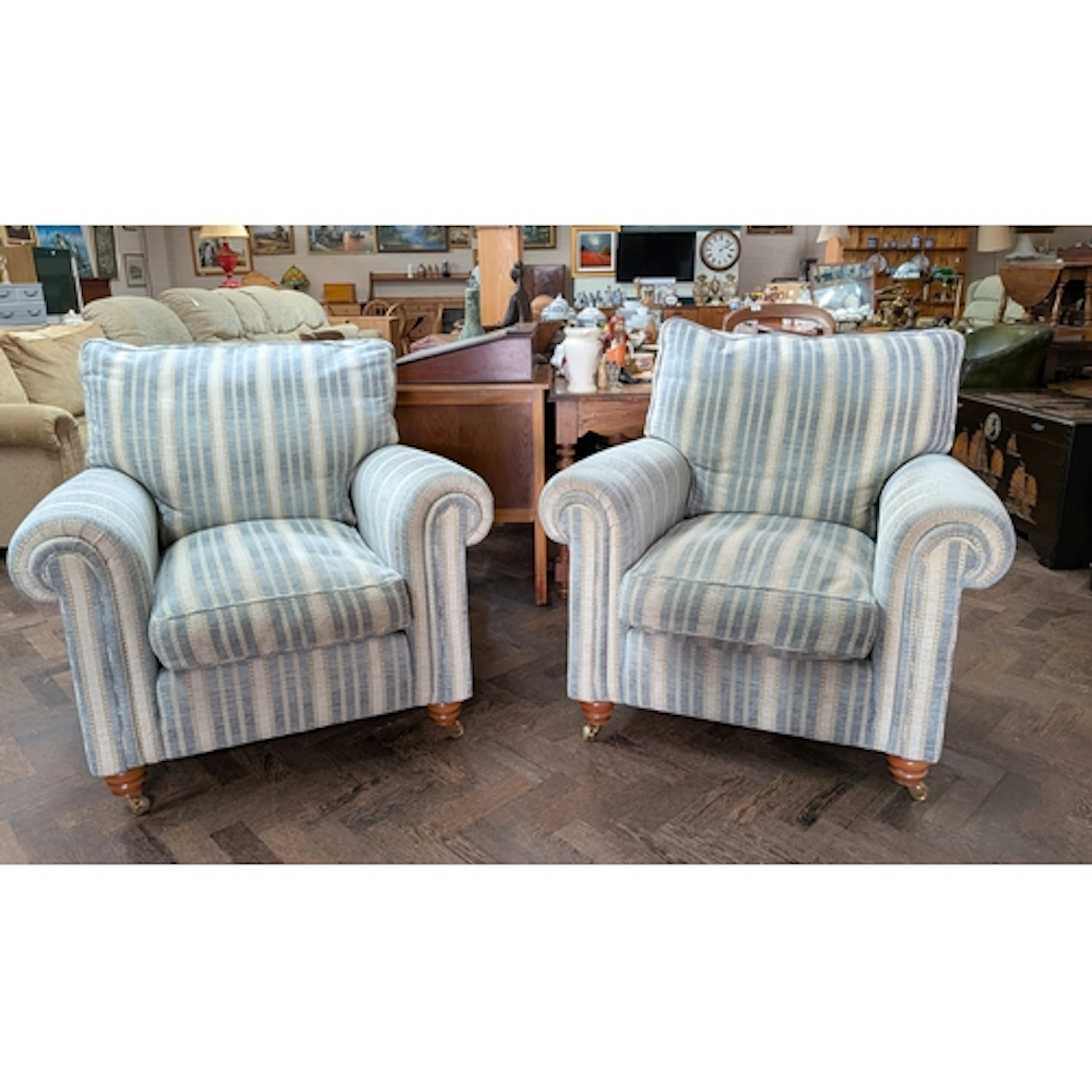 A pair of Duresta armchairs, the feather filled cushions uph...