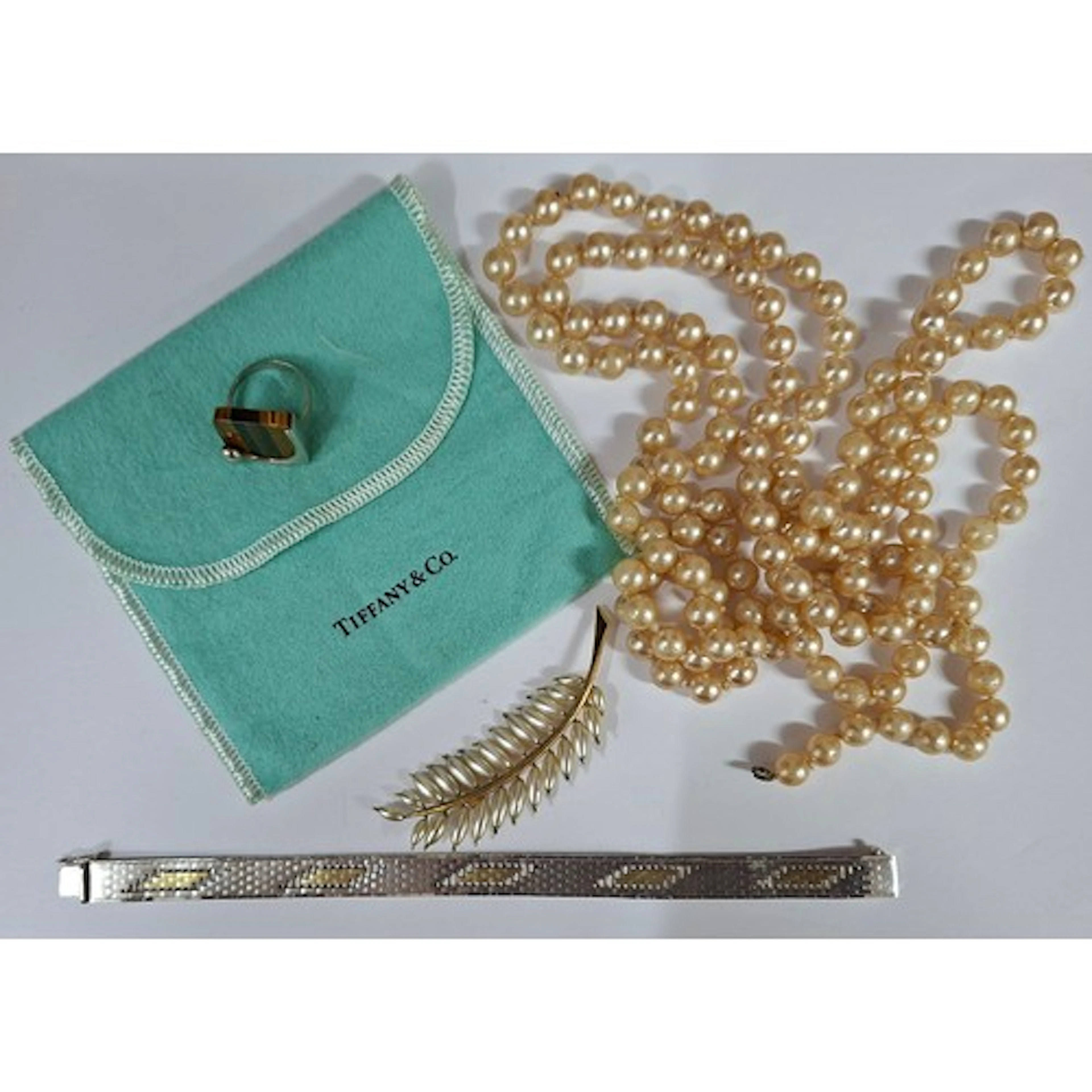 Tiffany & Co- An Elsa Peretti modernist silver and tiger's e...