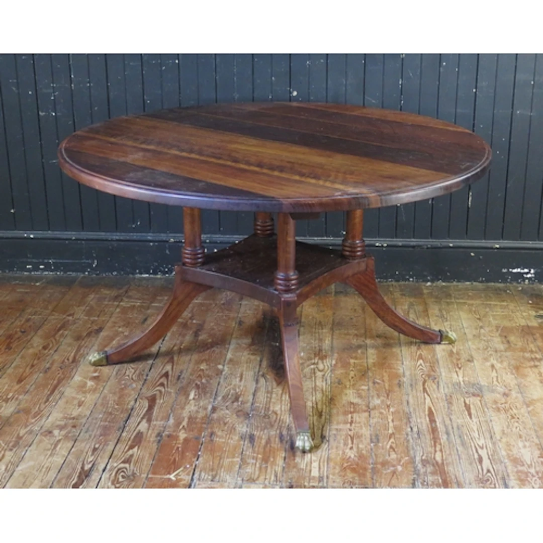An HMF & T laurel circular dining table, in the Regency tast...
