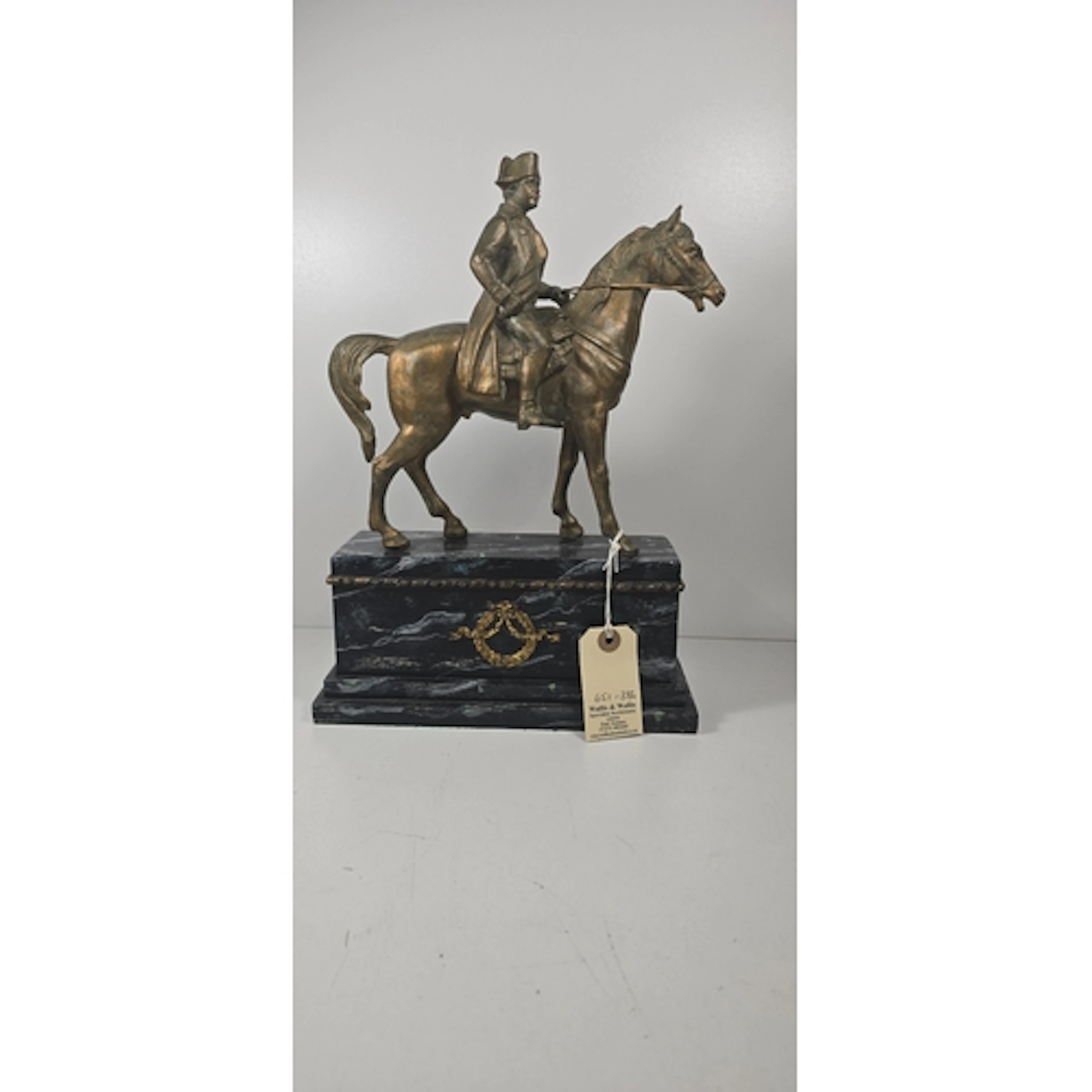 A gold painted spelter equestrian figure of Napoleon mounted...