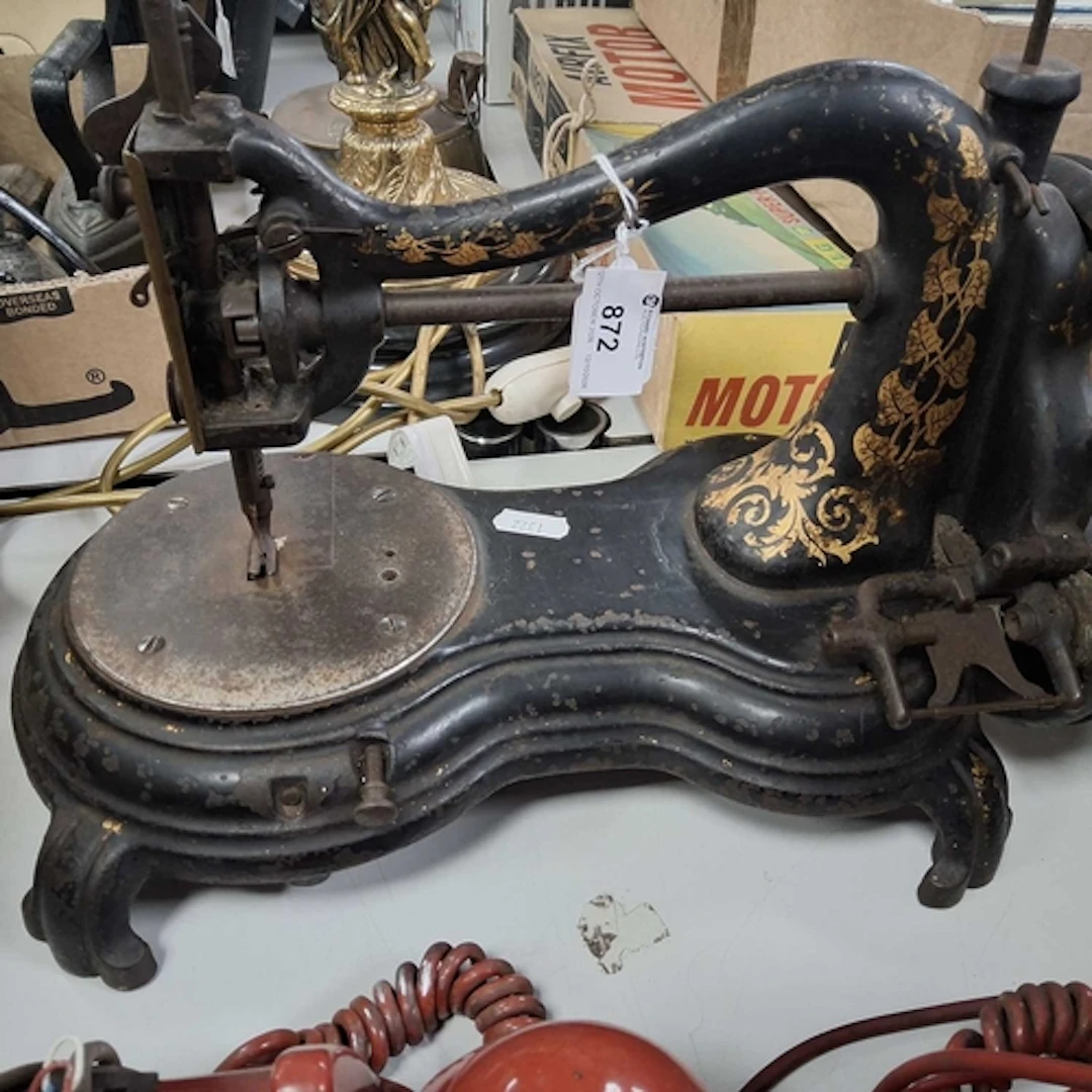 A VINTAGE JONES SWAN NECK SEWING MACHINE with gilt scrolling...