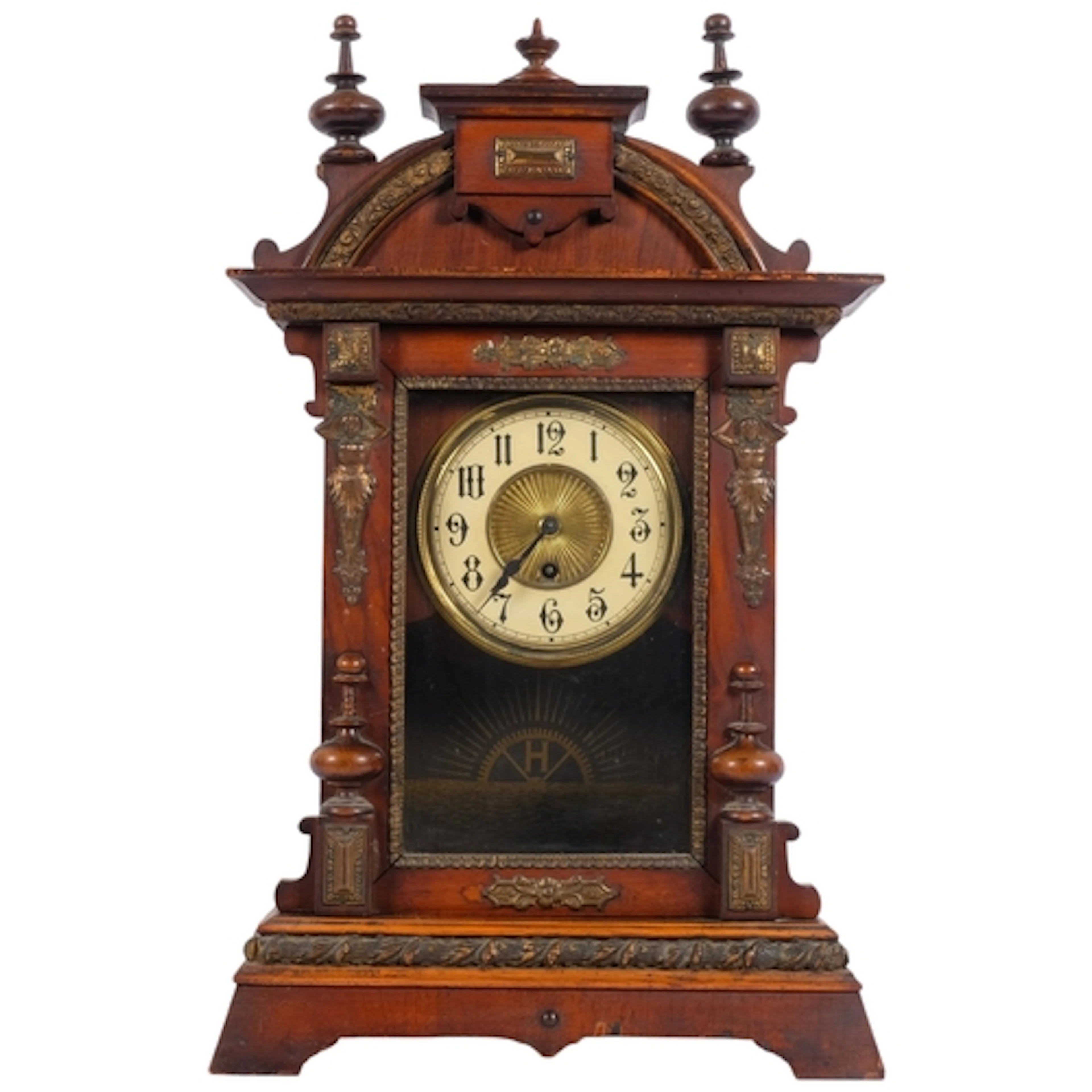 An American stained wood cased mantel clock, with embossed b...