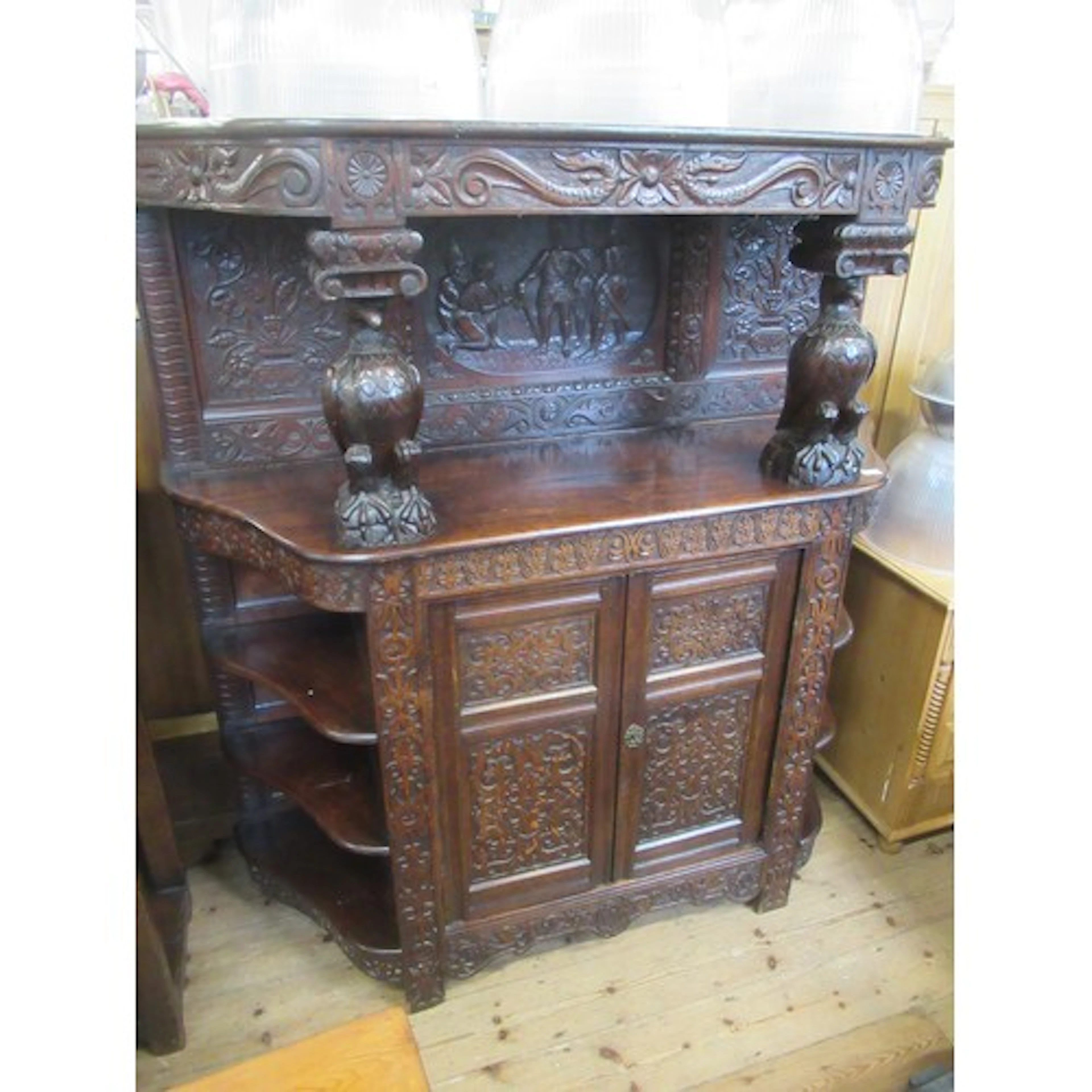 An antique style oak court cupboard the upper section raised...