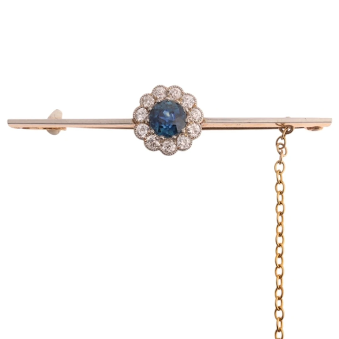 An 18ct gold sapphire and diamond cluster bar brooch, claw s...