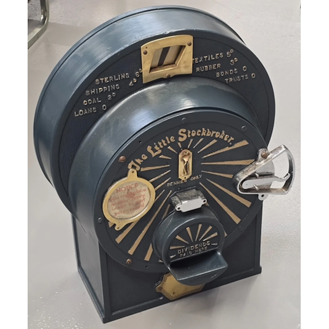 A vintage "The Little Stockbroker" coin operated penny machi...