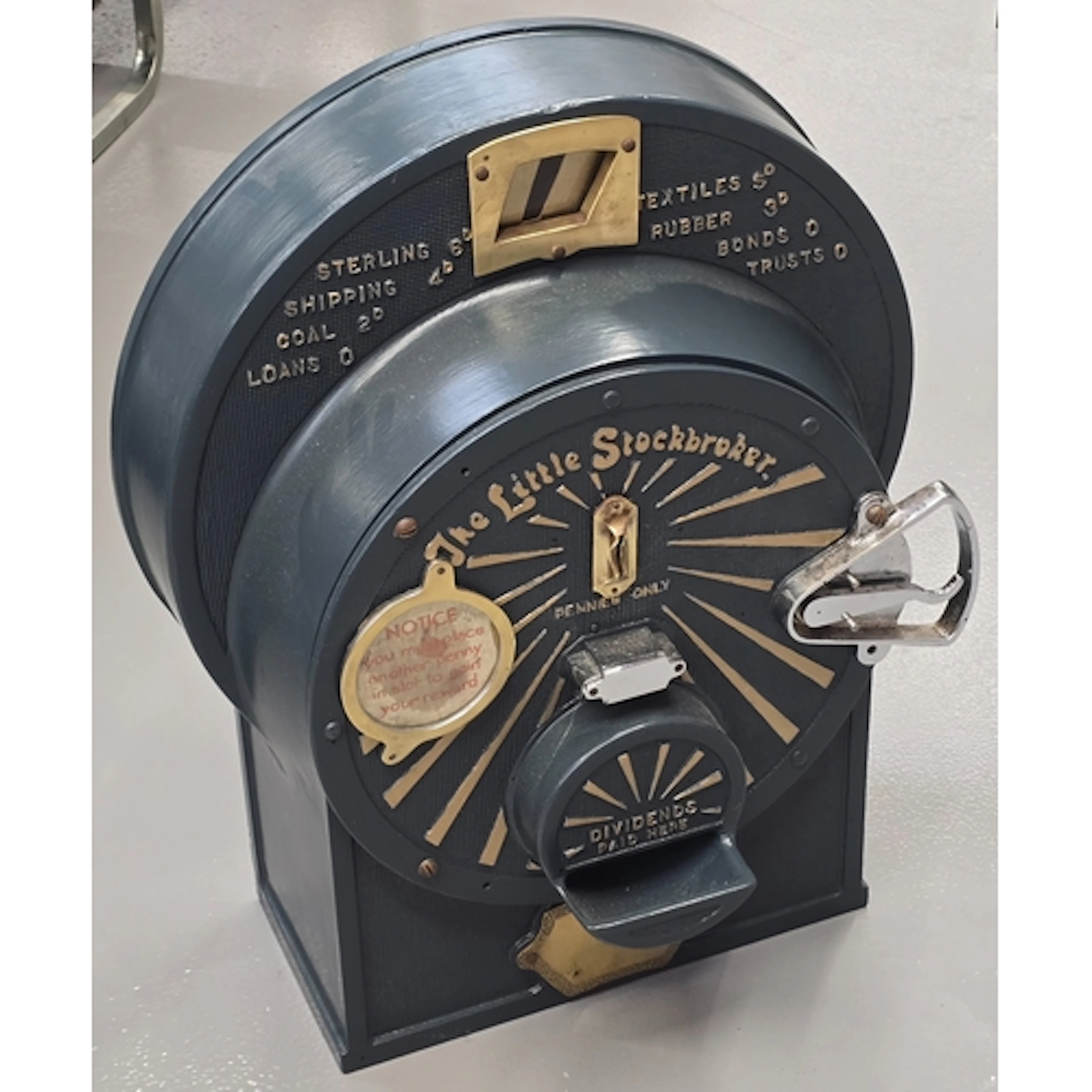 A vintage "The Little Stockbroker" coin operated penny machi...