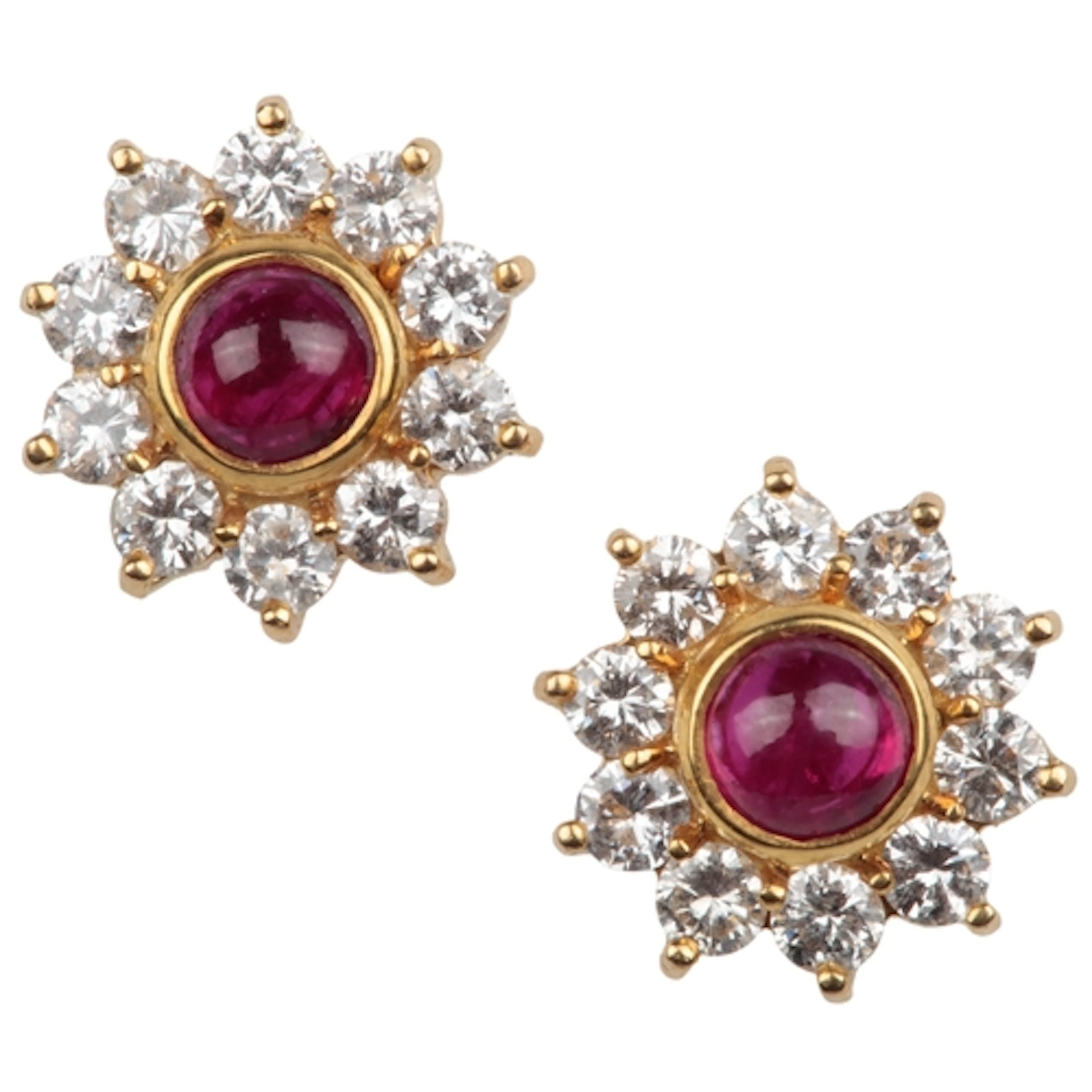 A pair of ruby and diamond cluster earrings, each set with a...