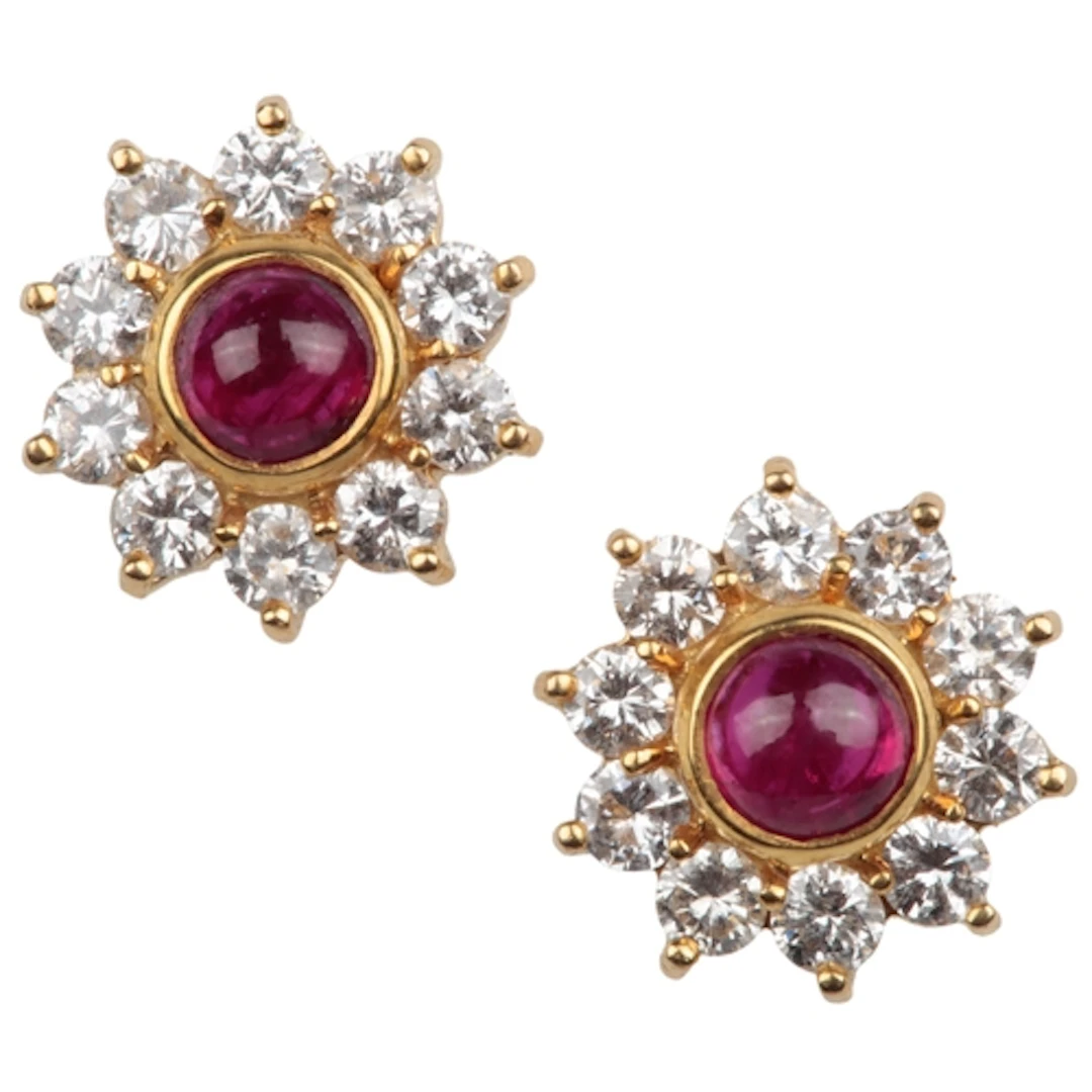 A pair of ruby and diamond cluster earrings, each set with a...