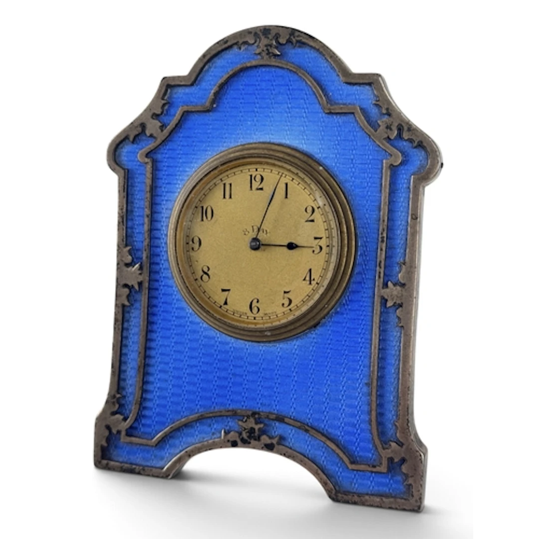 AN ART DECO SILVER AND BLUE GUILLOCHE ENAMEL DESK CLOCK In b...
