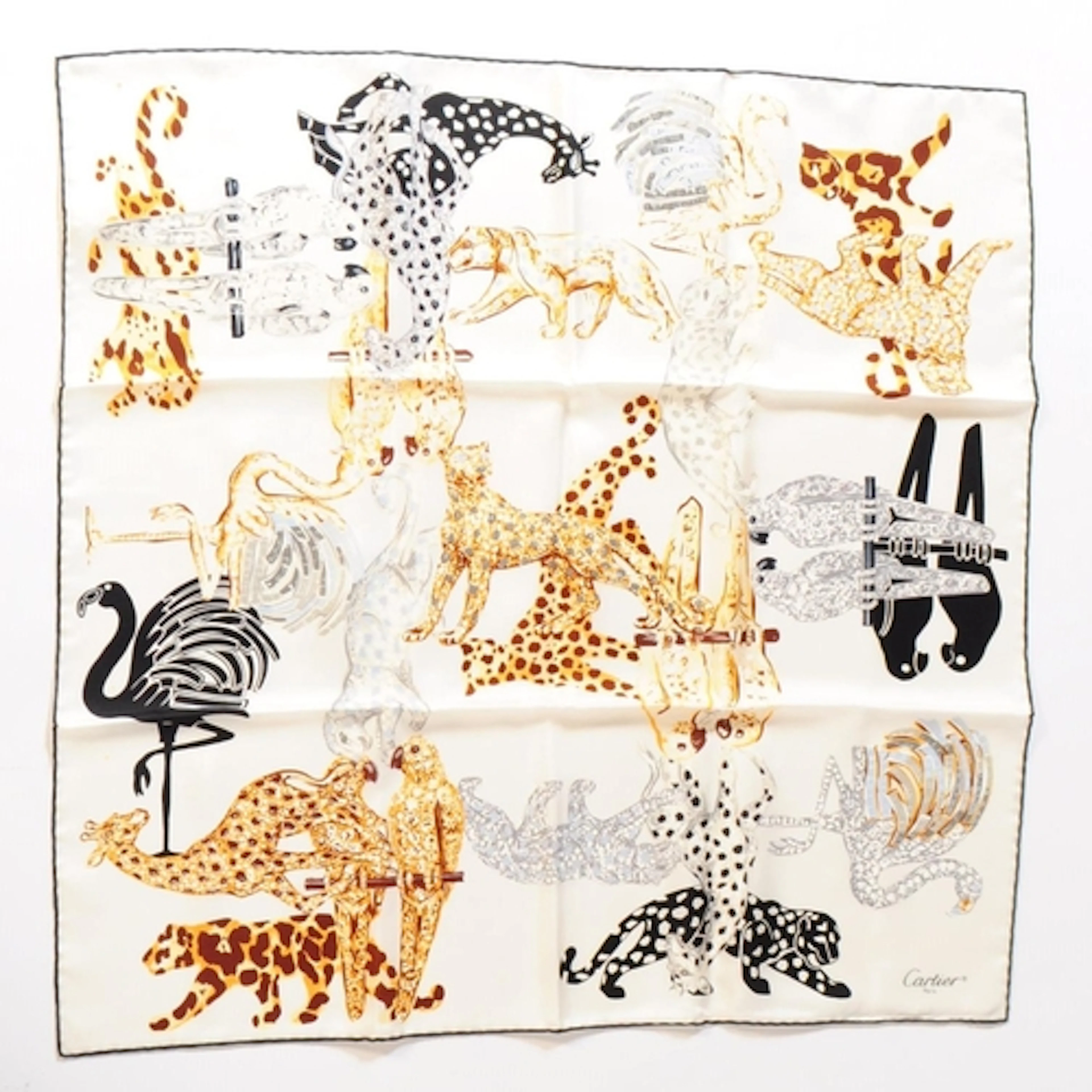 A Cartier printed silk scarf. The scarf printed with their i...