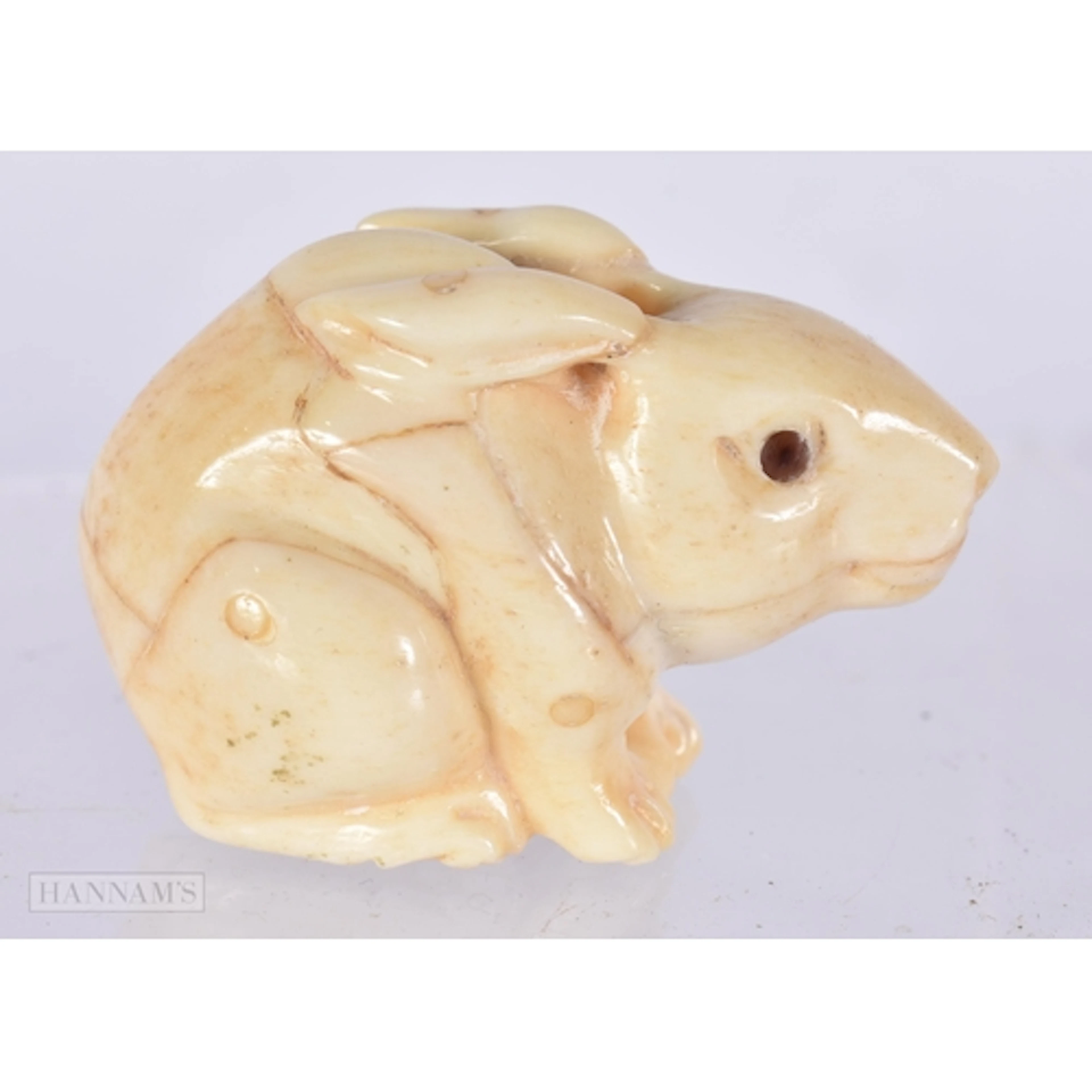 A BONE RABBIT NETSUKE. 3 x 4.4 x 2.8 cm