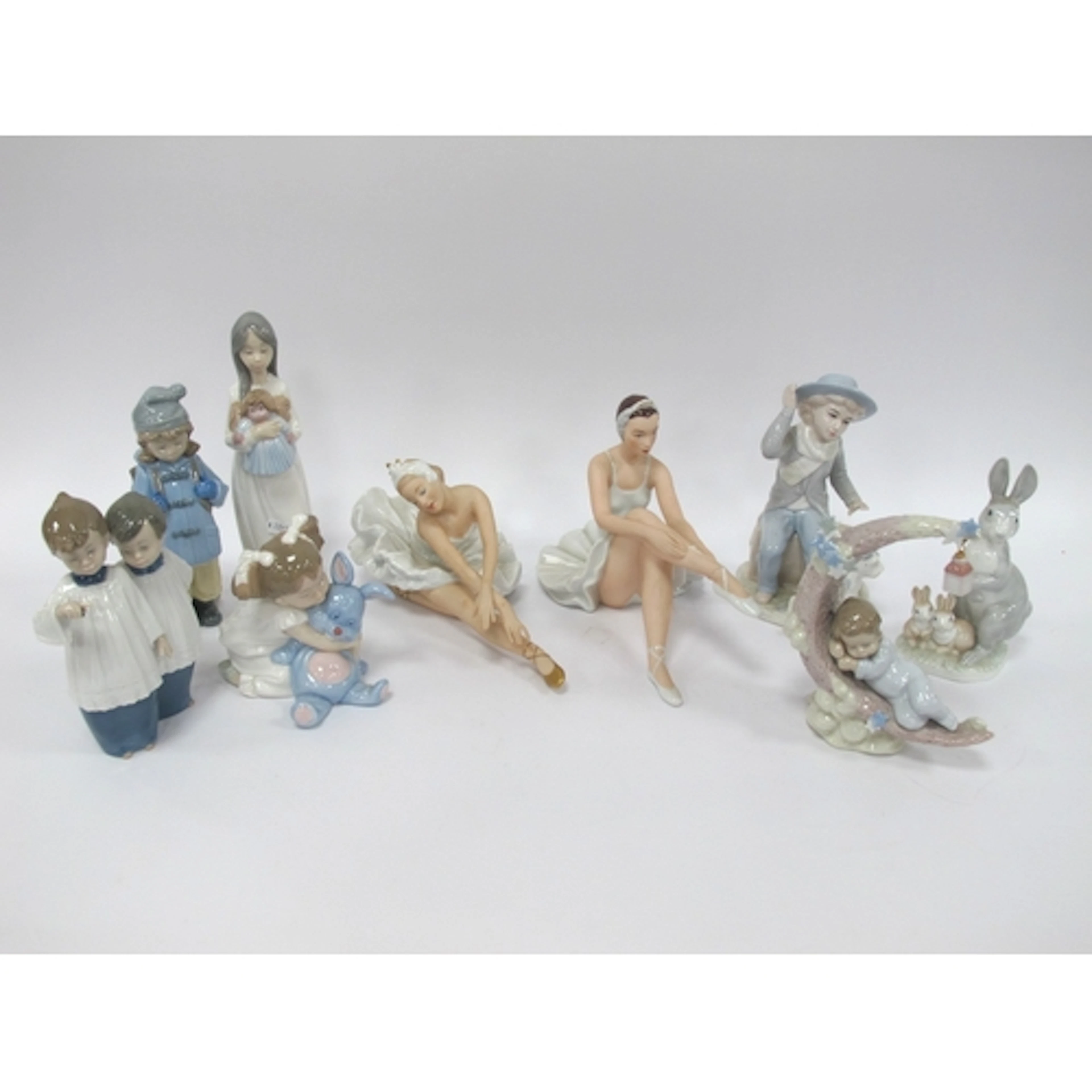 Nine Porcelain Figures, including Lladro 6479 "Heavenly Slum...