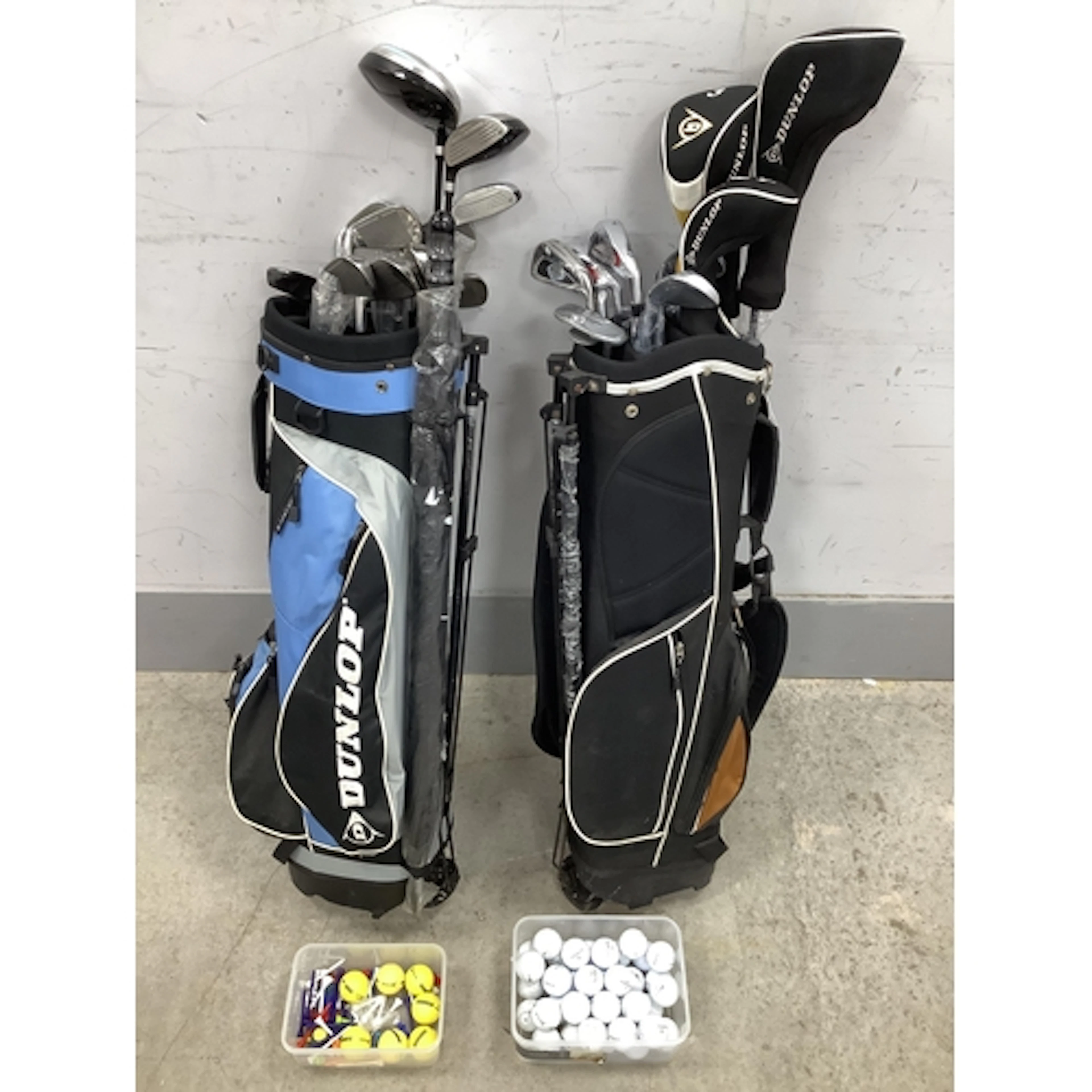 Golf, approx 23 Dunlop Clubs and Umbrellas in two carry bags...