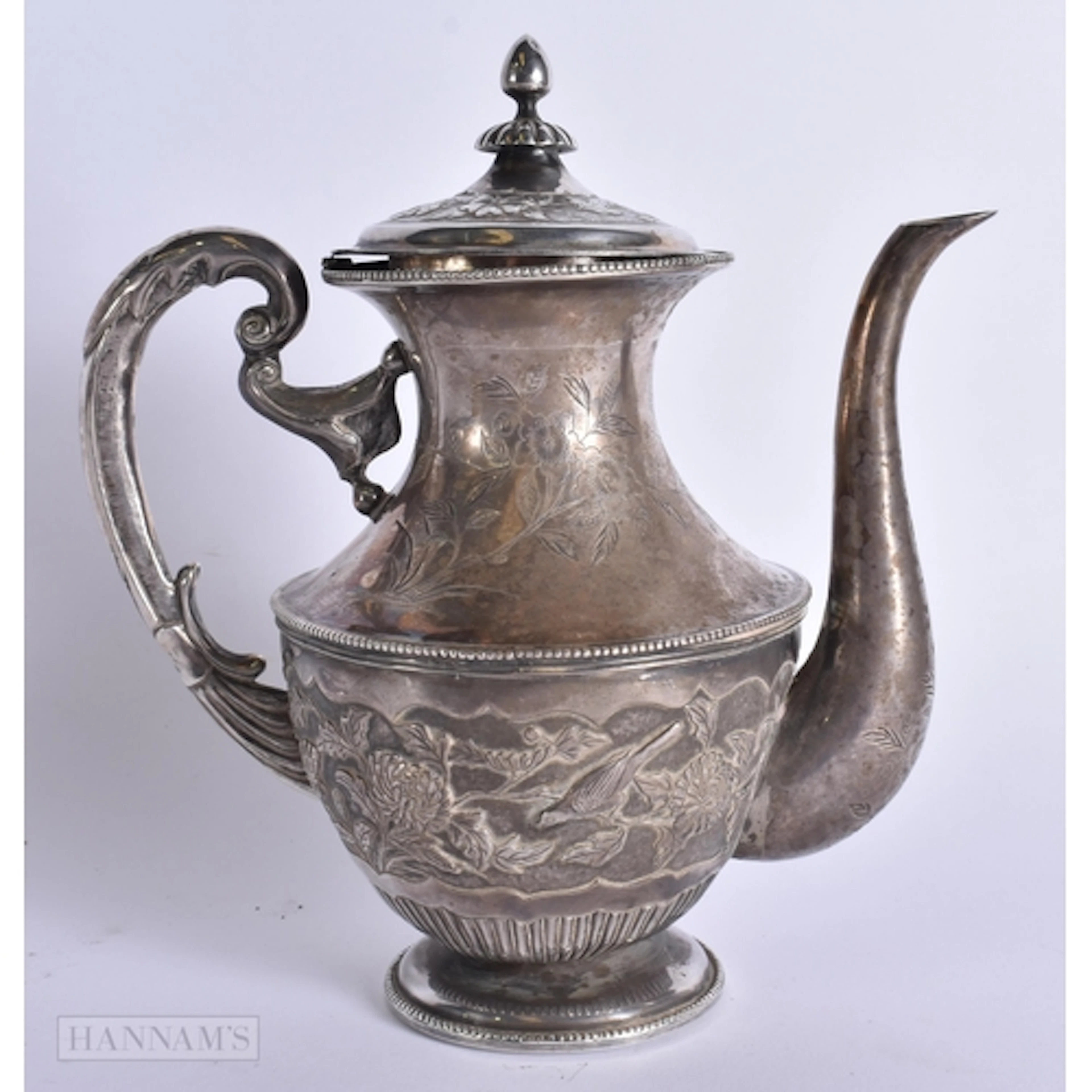 AN ANTIQUE EASTERN WHITE METAL COFFEE POT decorated with bir...