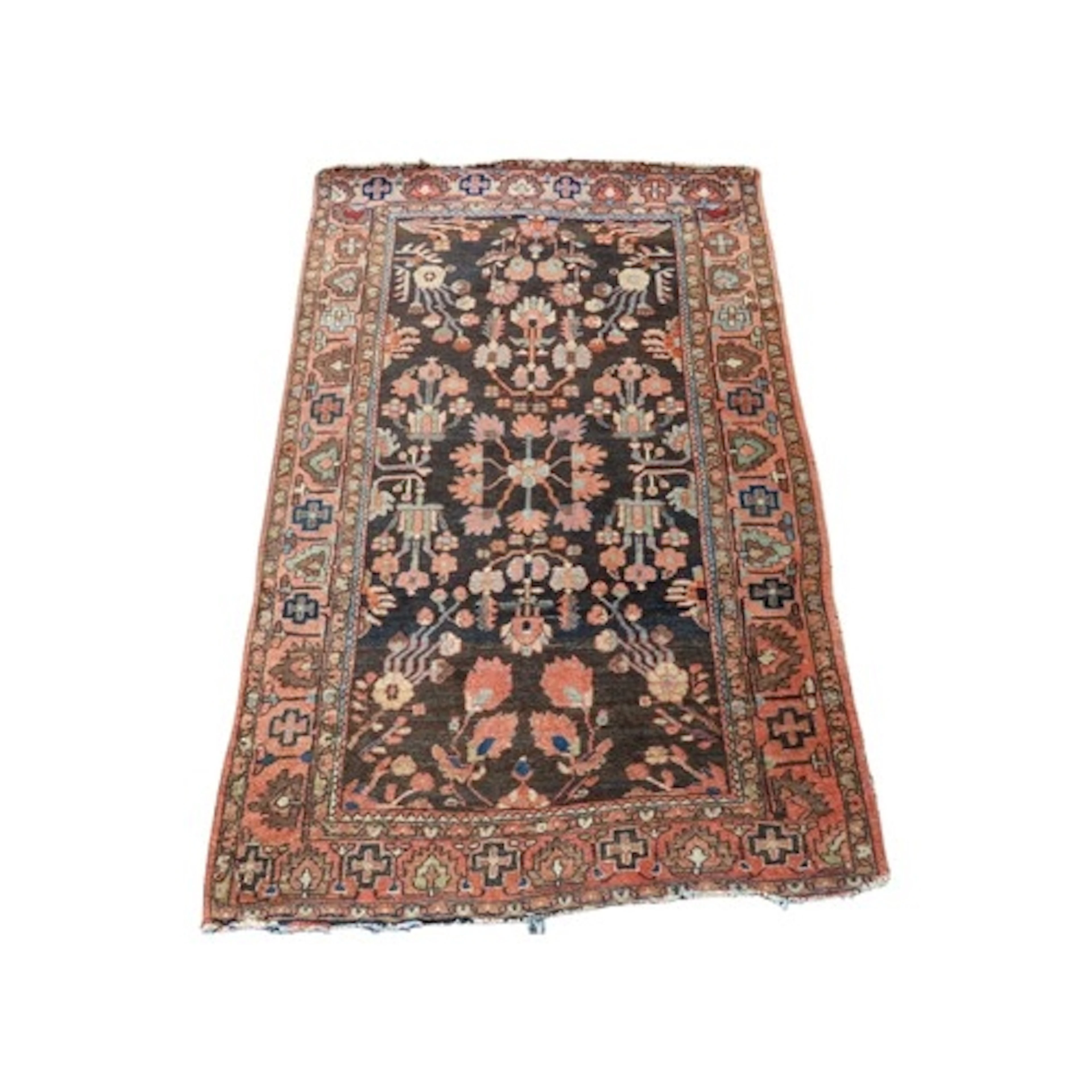 An old Persian wool rug with floral panels set upon an ink b...