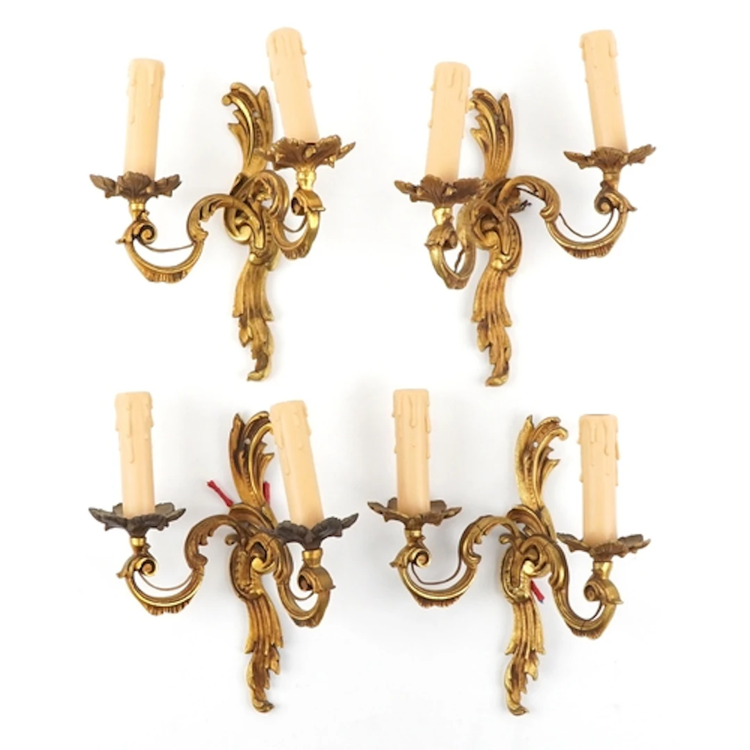 Set of four gilt brass wall sconces, 26cm high.