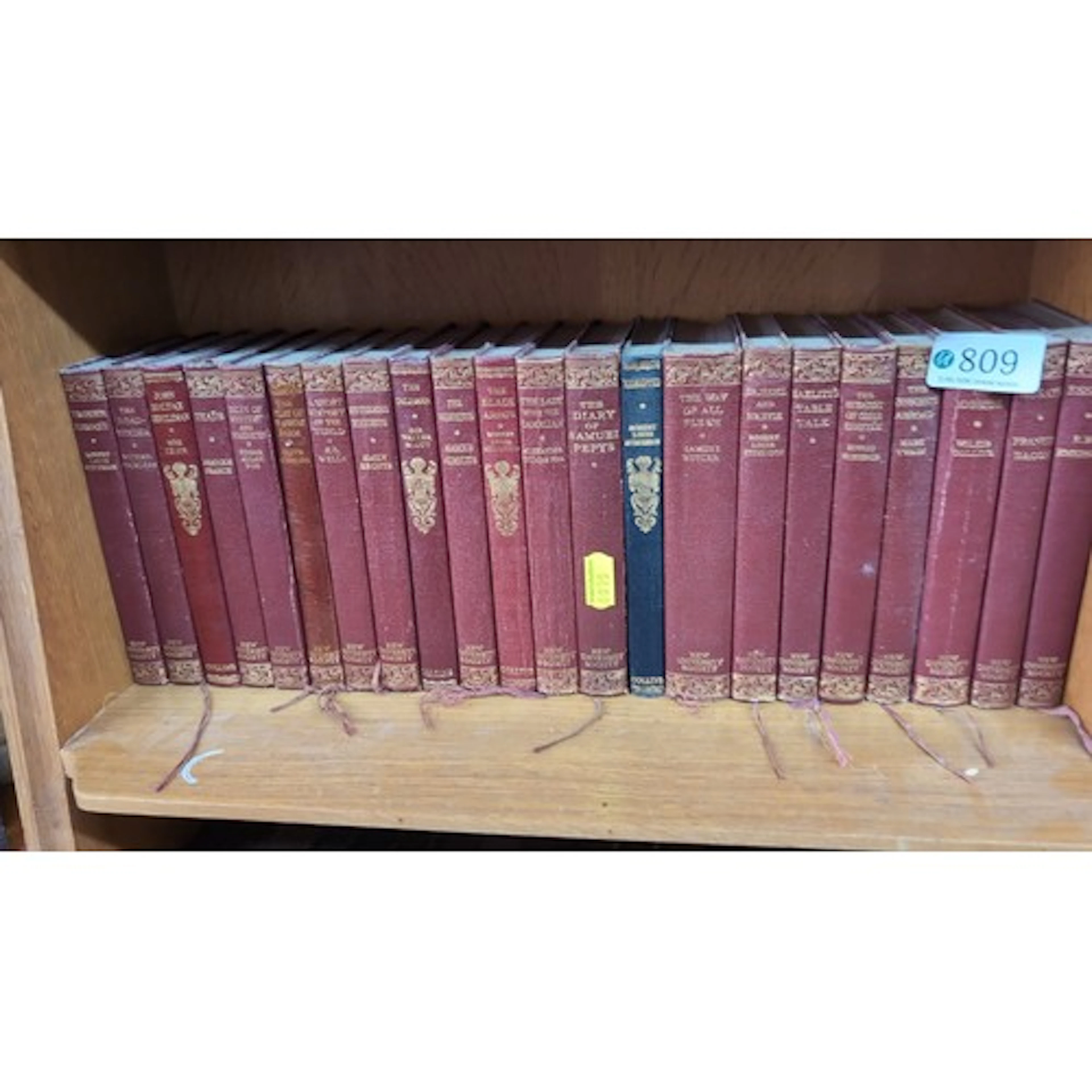 A set of gilt-tooled red cloth-bound classics, New Universit...