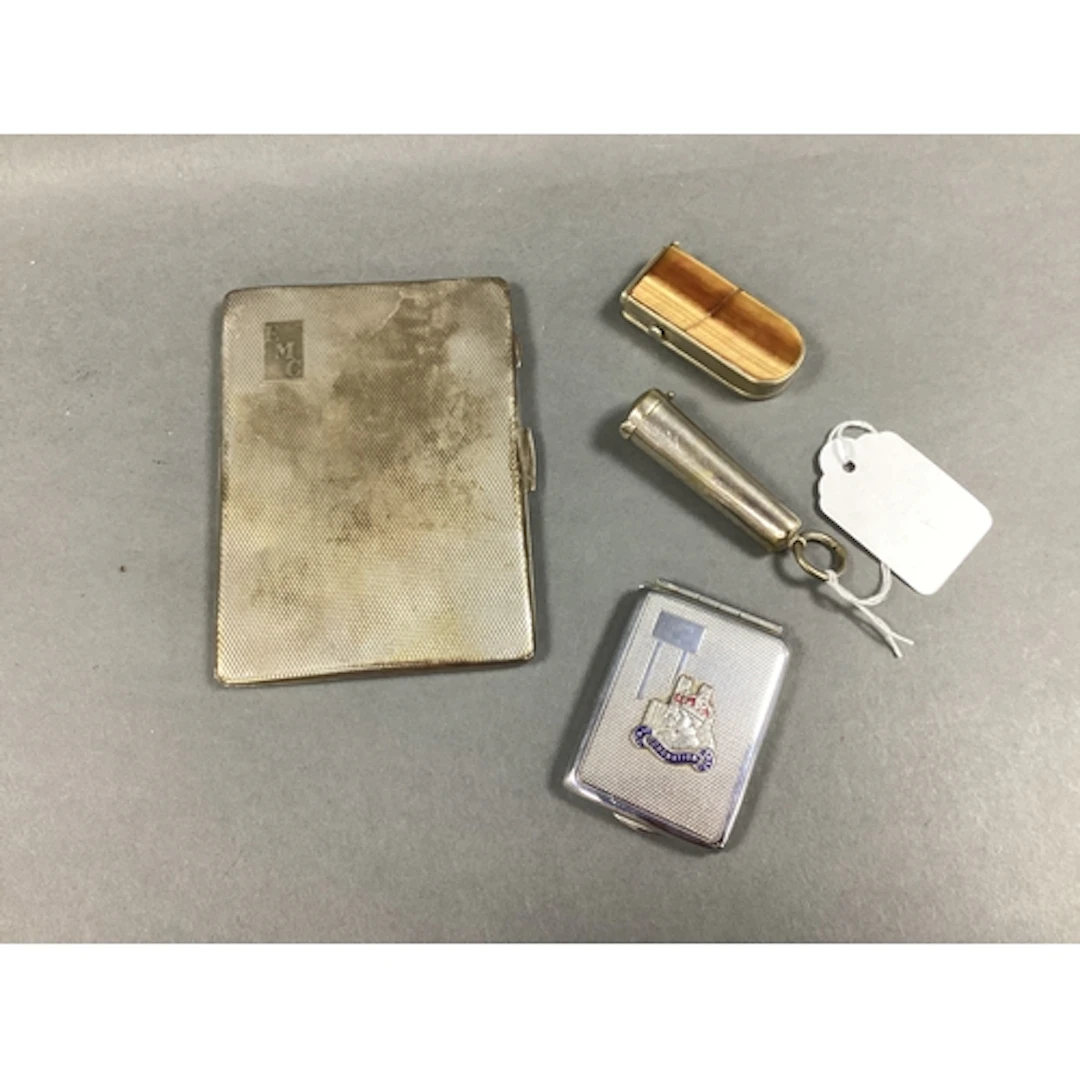 An Engine Turned Cigarette Case, engraved "E M C", gilt line...