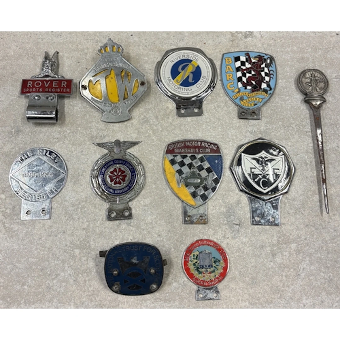 A collection of ten car badges to include the Rover Sport Re...