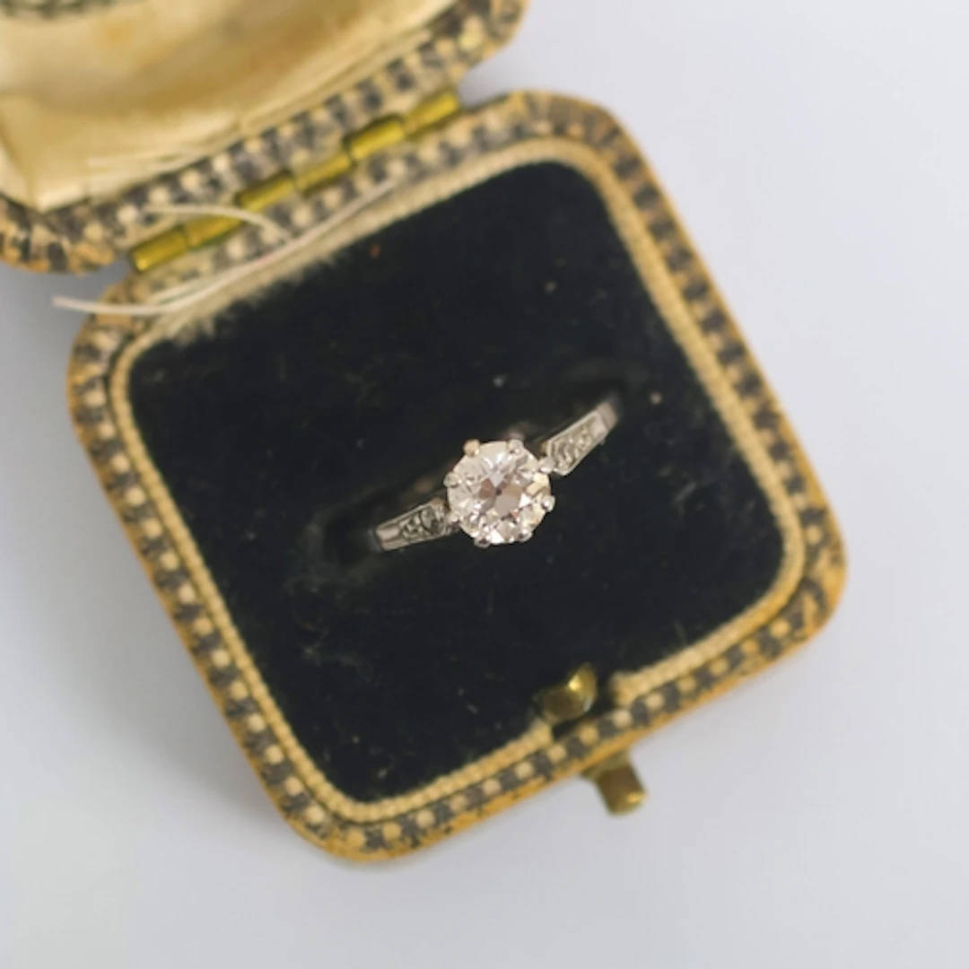 An Art Deco diamond solitaire, the old cut diamond within cl...