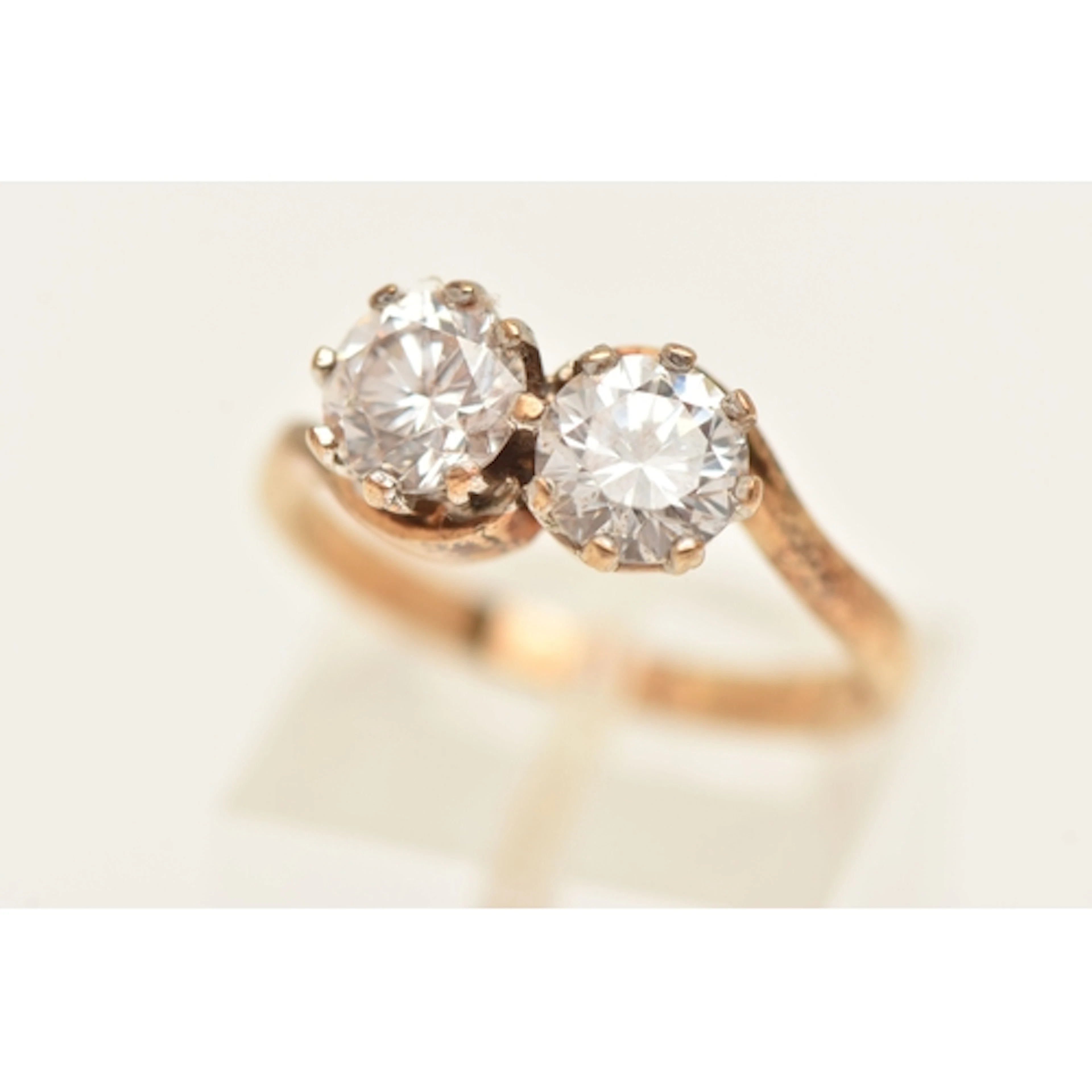 A 9CT GOLD TOI ET MOI RING, two circular cut cubic zirconia,...