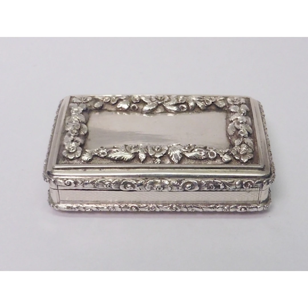 An early Victorian silver snuff box having engine turned and...