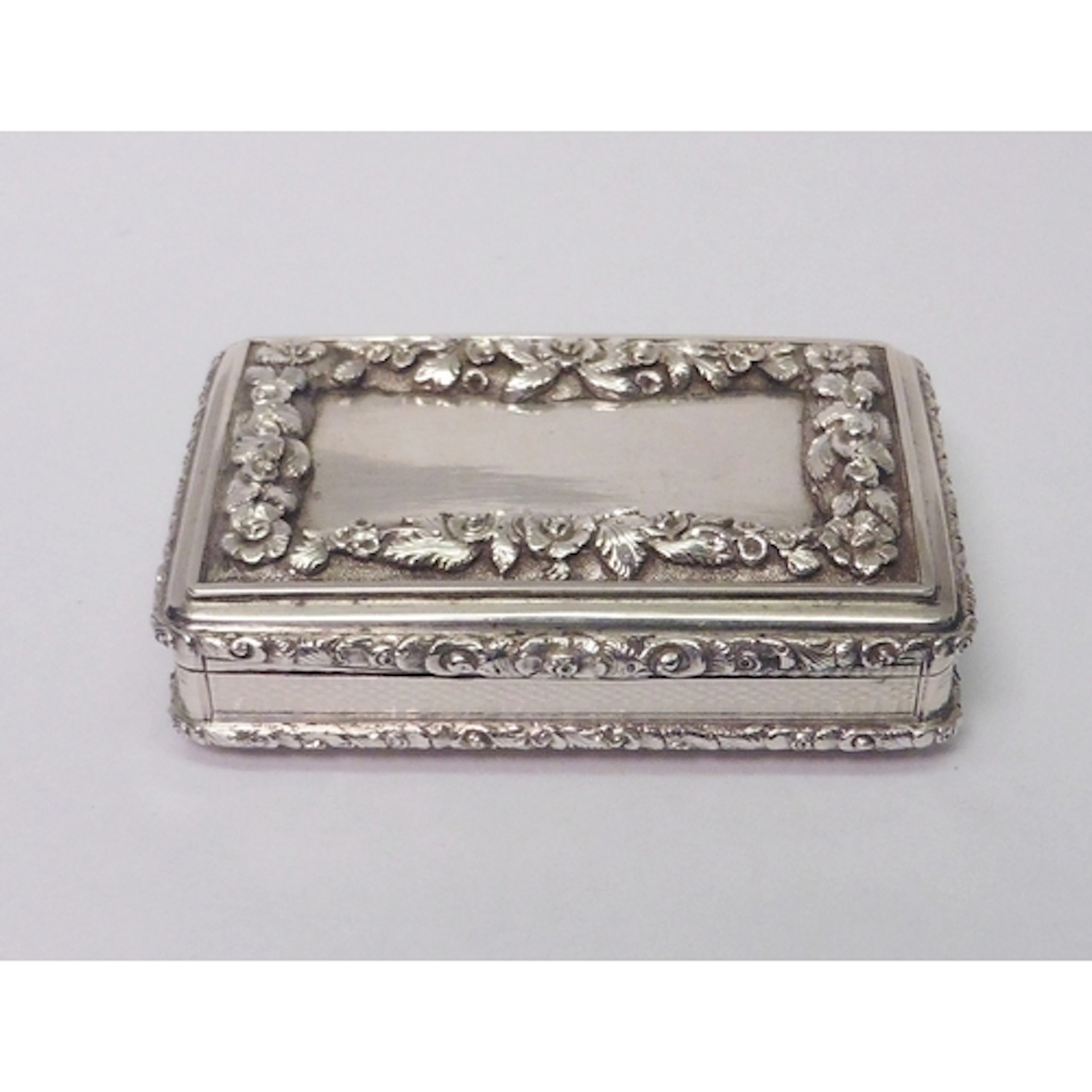 An early Victorian silver snuff box having engine turned and...