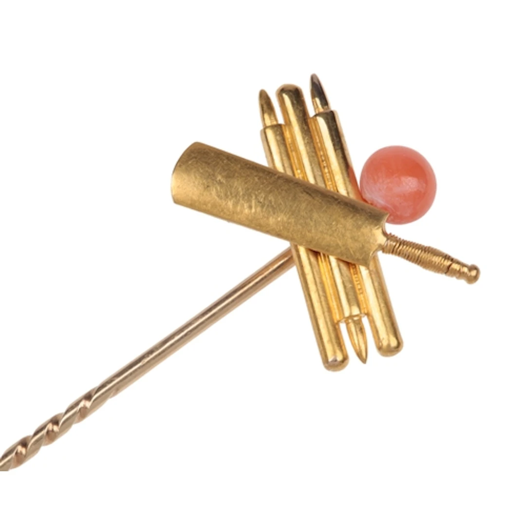 A gold and coral stick pin, early 20th century, designed as ...