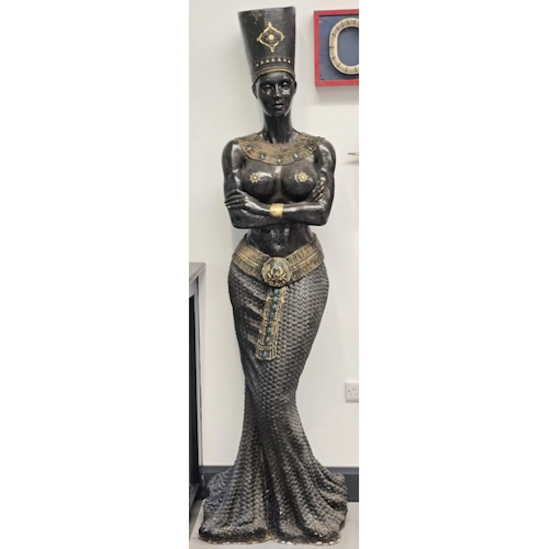 A large decorative floor statue in an Egyptian revival style...