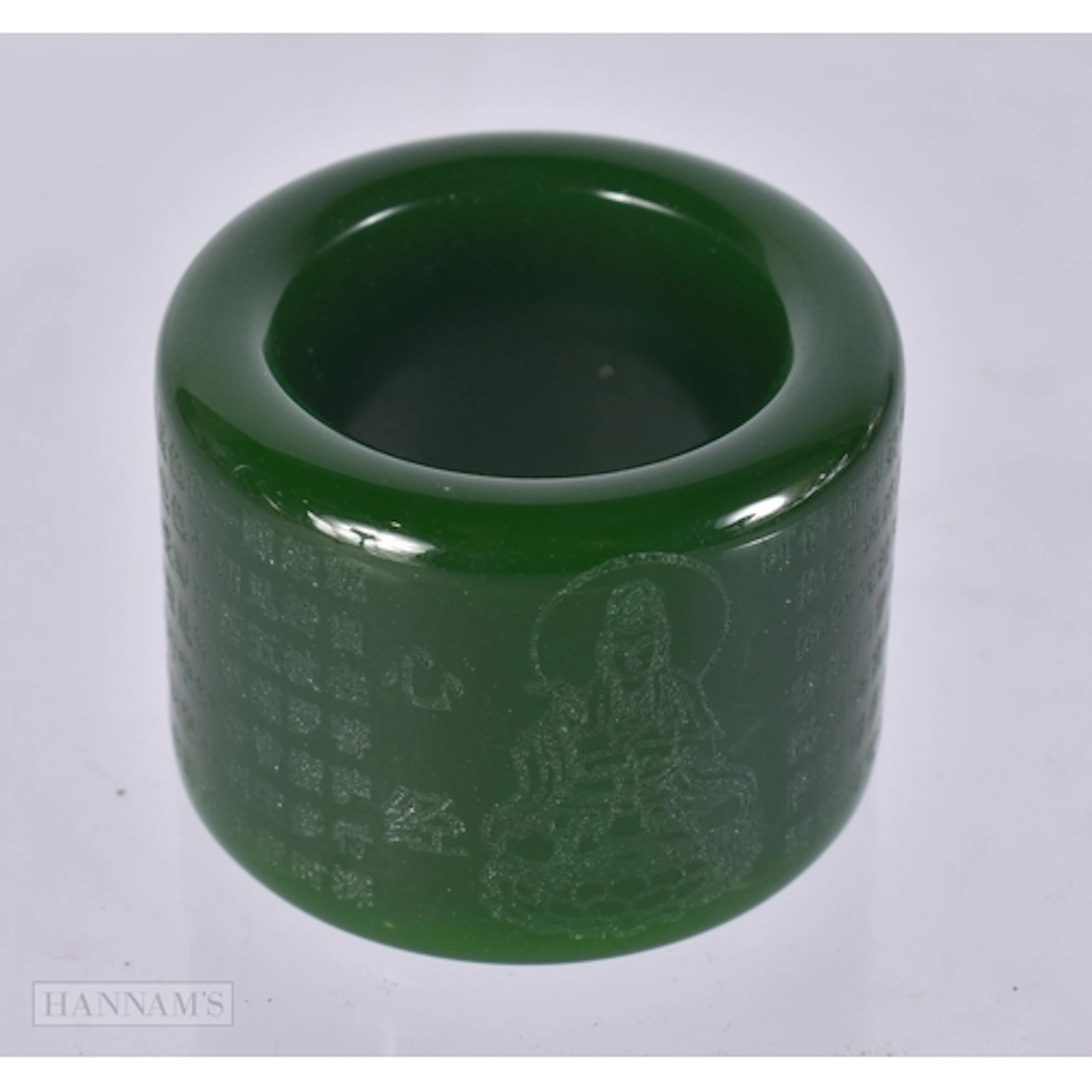 A SPINACH JADE ARCHERS RING. size z