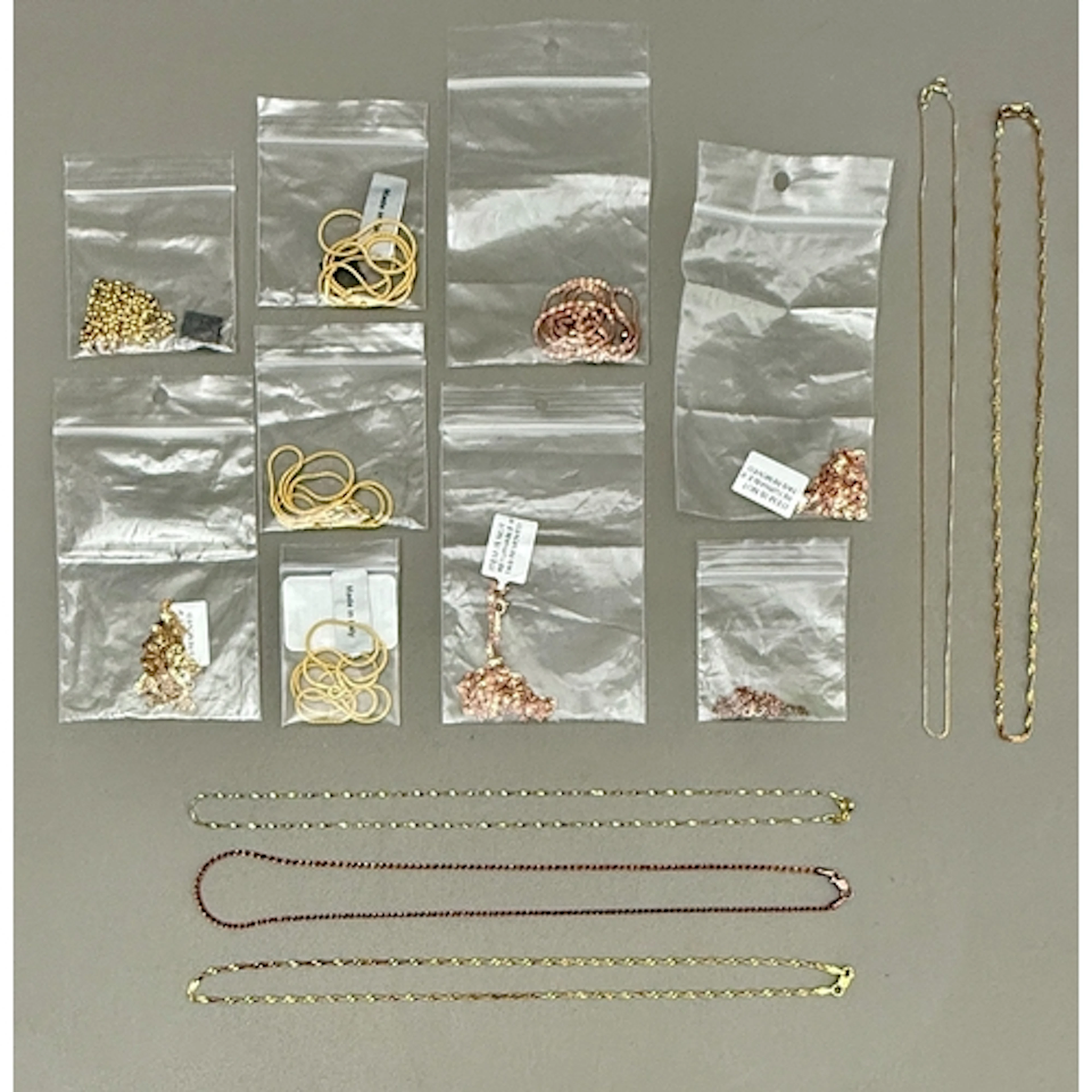 Fourteen silver gilt and silver rose-gilt chains / necklaces...