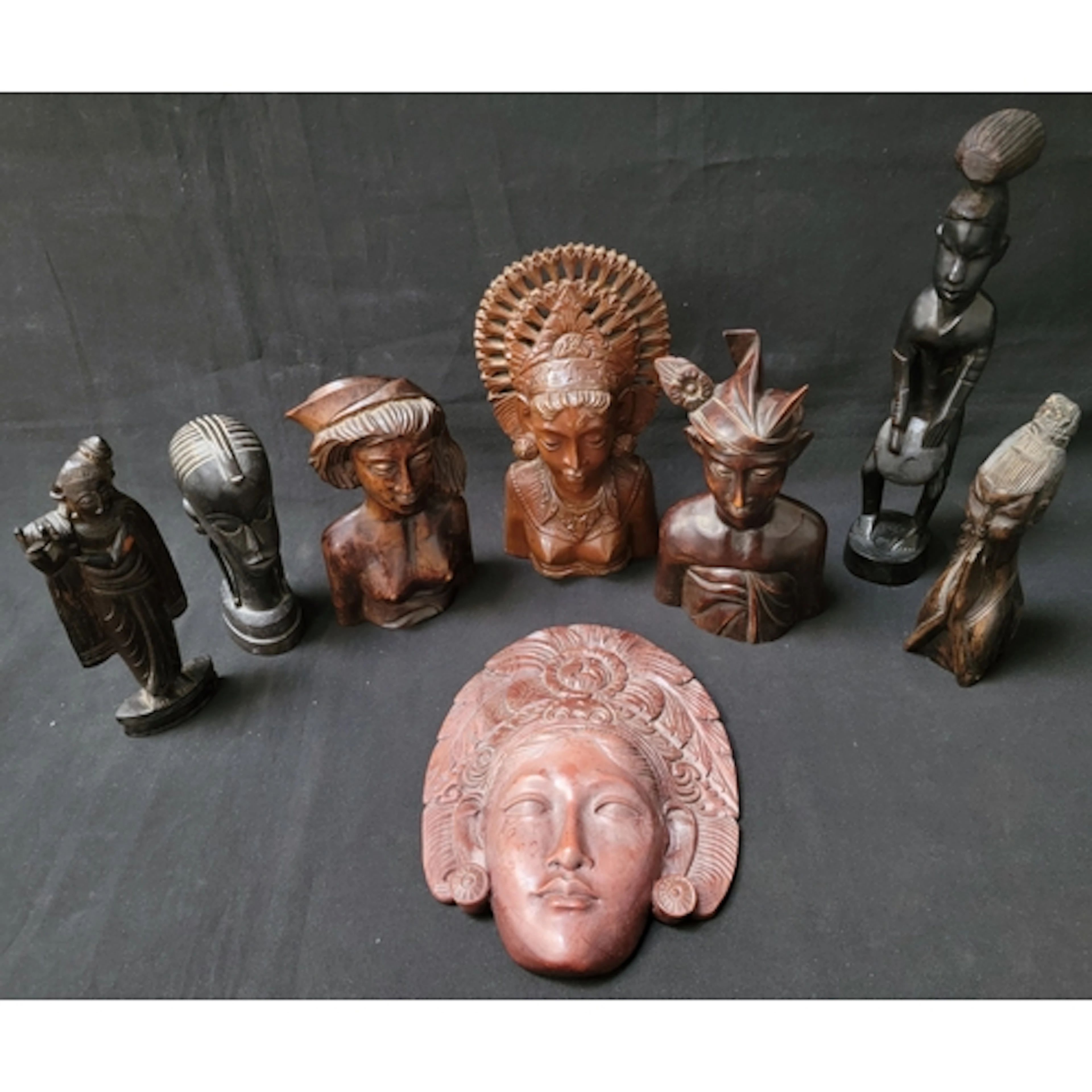 SELECTION OF EIGHT WOODEN FIGURINES including examples from...