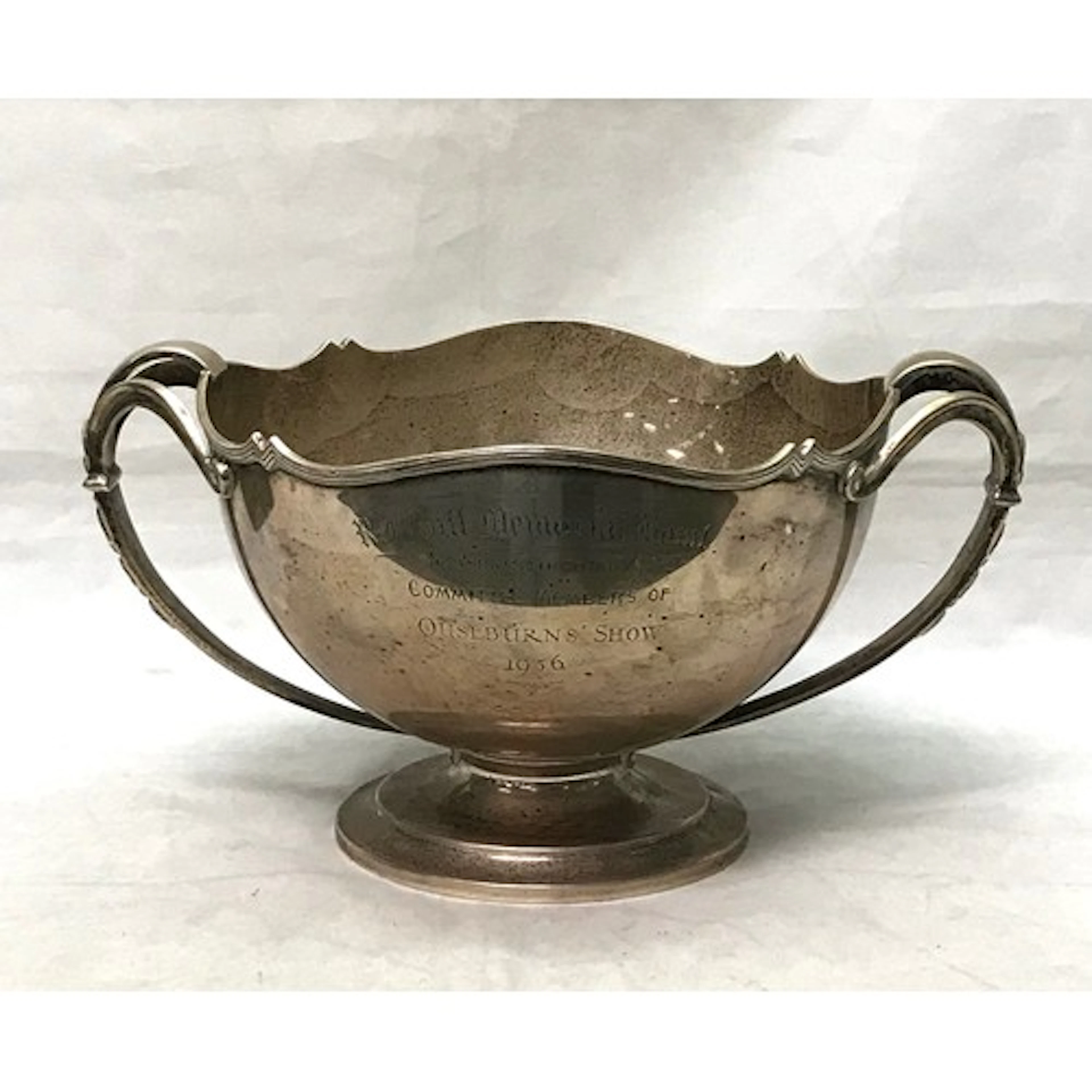 A silver two-handled trophy bowl bearing presentation engrav...