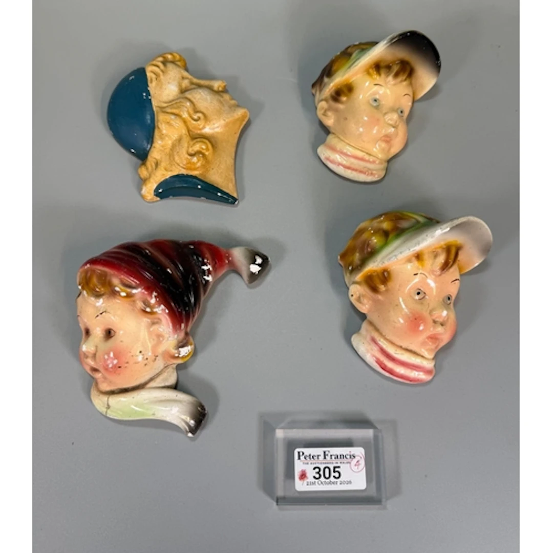 Four ceramic wall masks, one of an Art Deco style lady. (4) ...