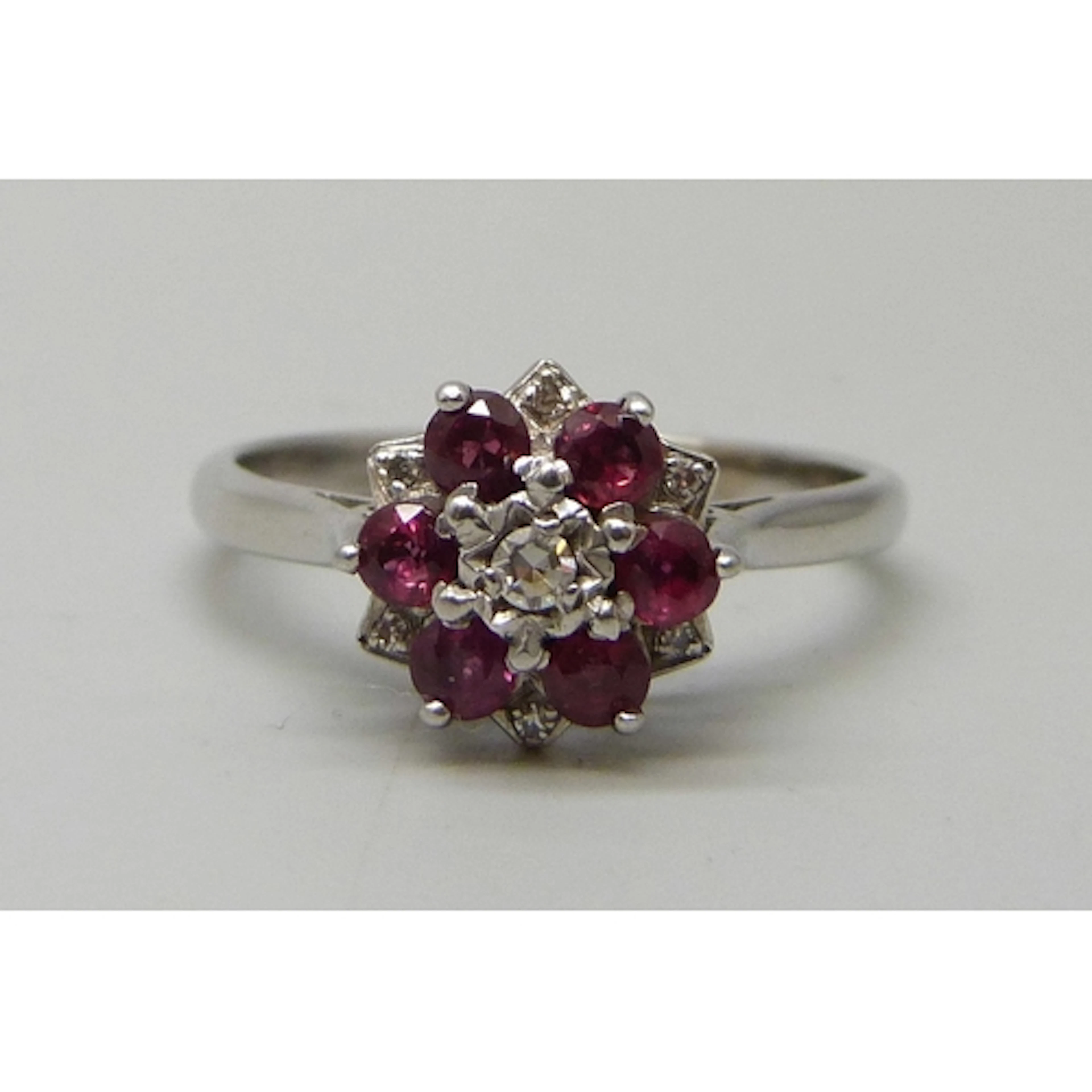 An 18ct white gold, ruby and diamond cluster ring, 4.4g, S