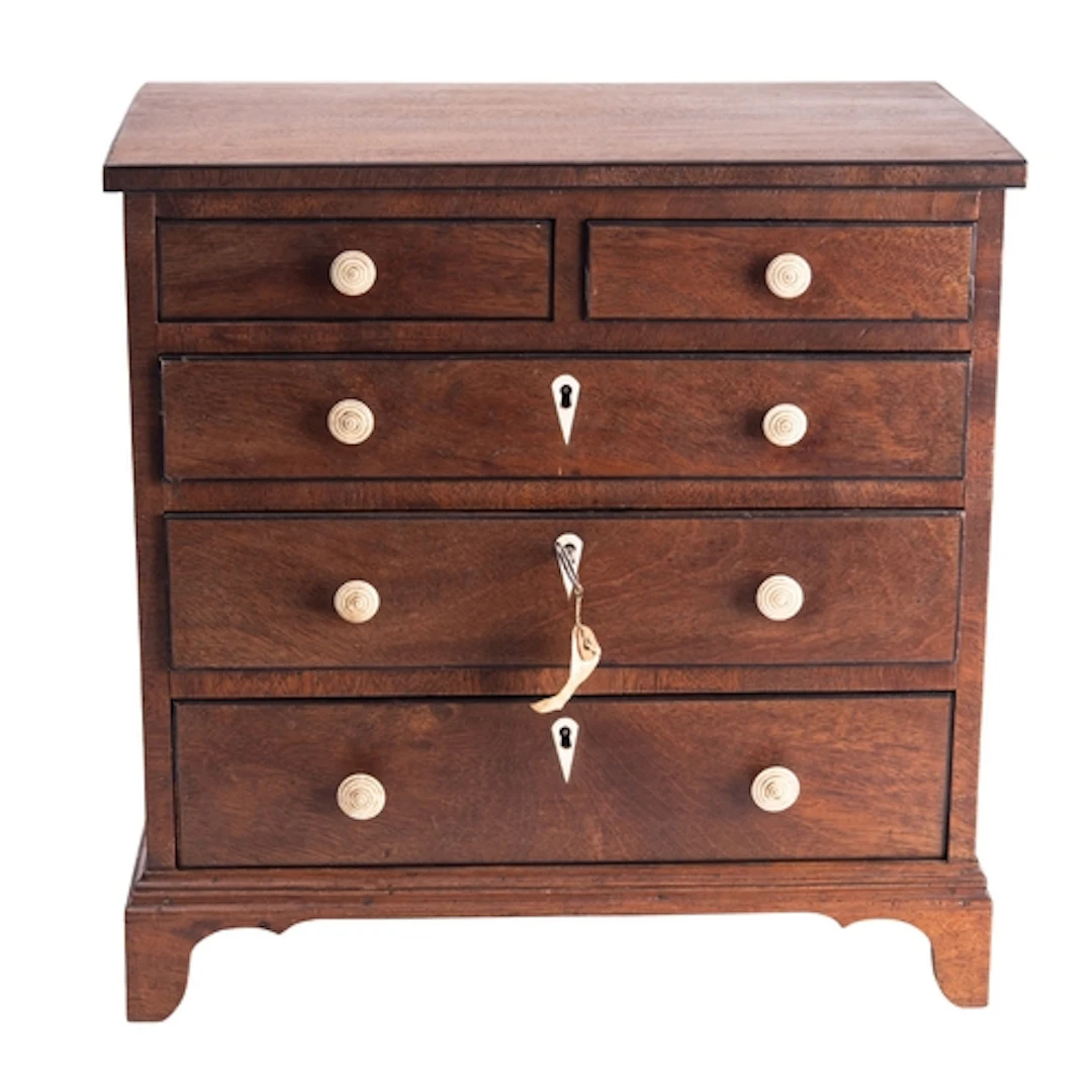 A miniature mahogany and ebony banded chest of drawers in Re...