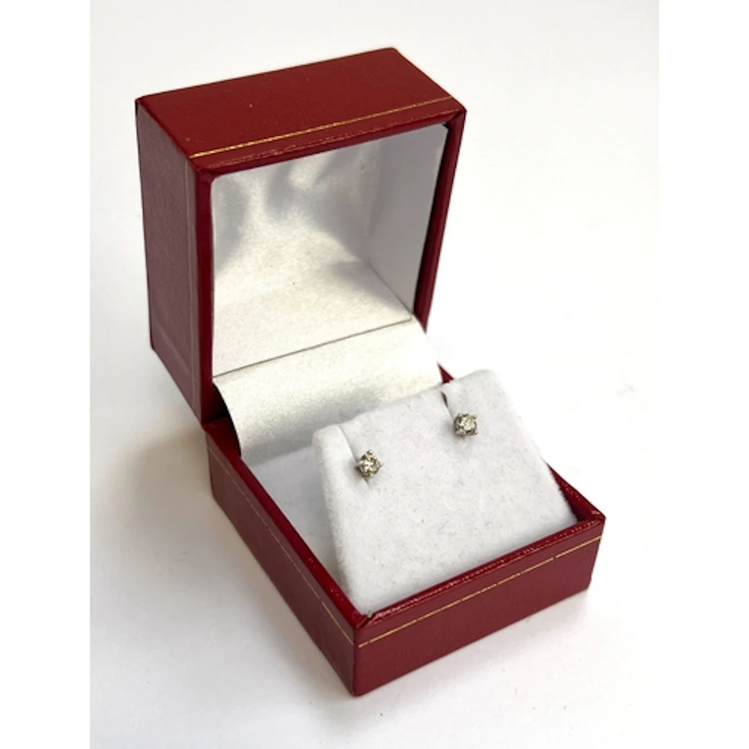 A pair of 14ct white gold and diamond solitaire stud earring...