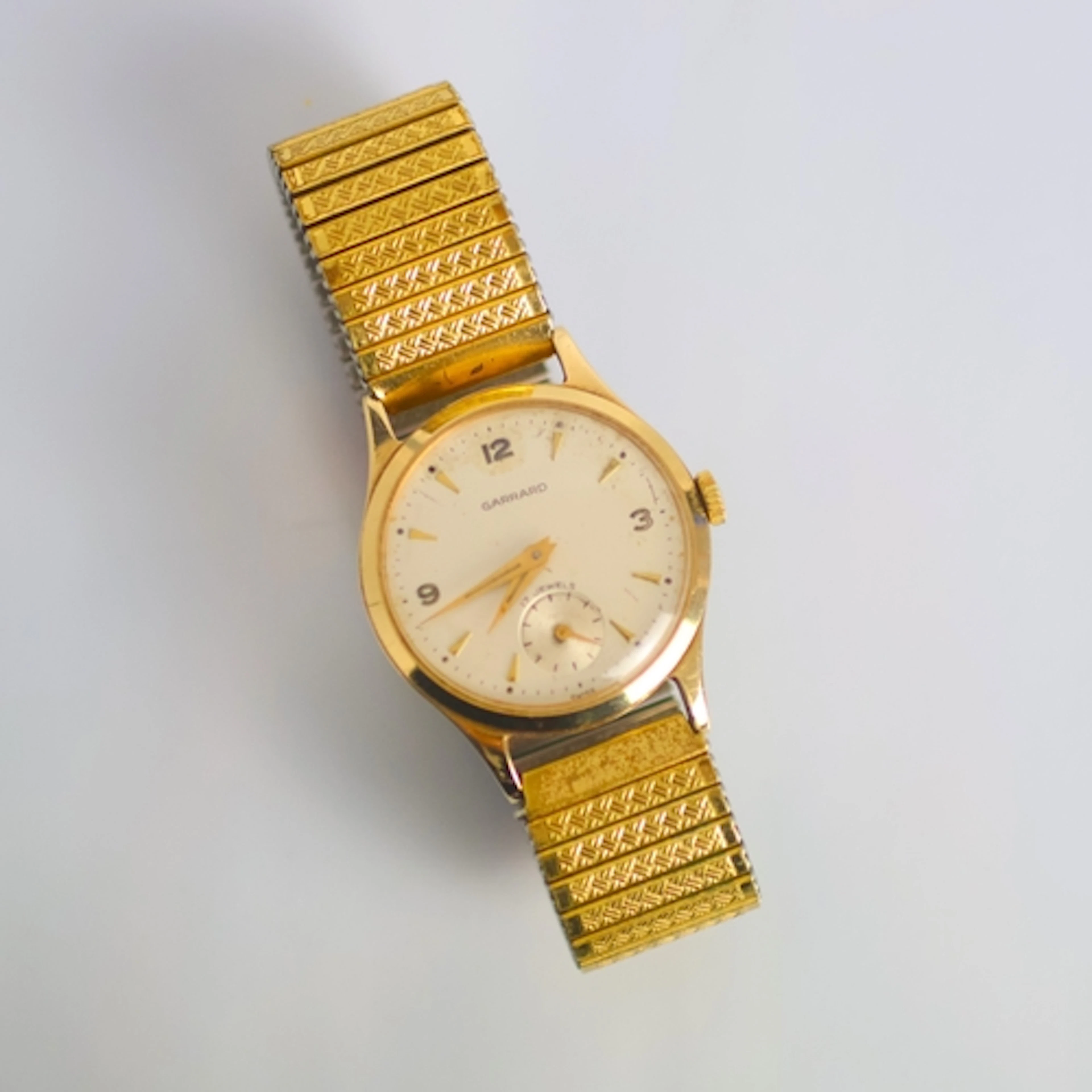 A mid 20th century 9ct gold cased Garrard wristwatch, the ci...