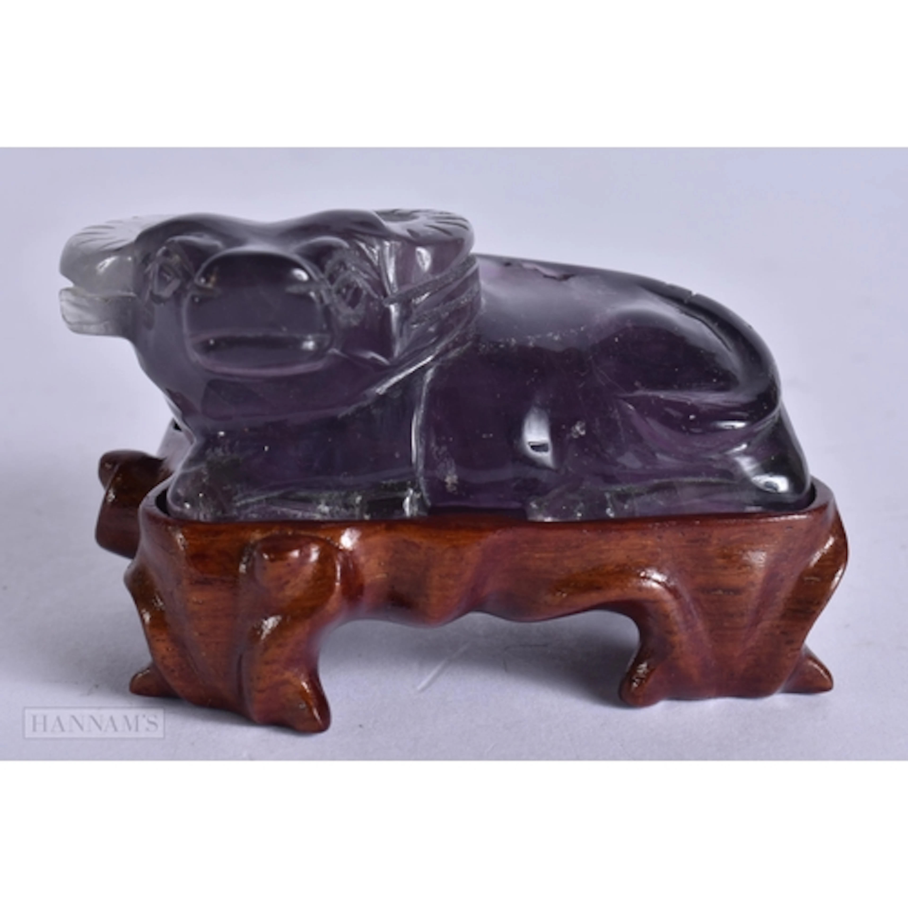 AN EARLY 20TH CENTURY CHINESE CARVED AMETHYST FIGURE OF A BU...