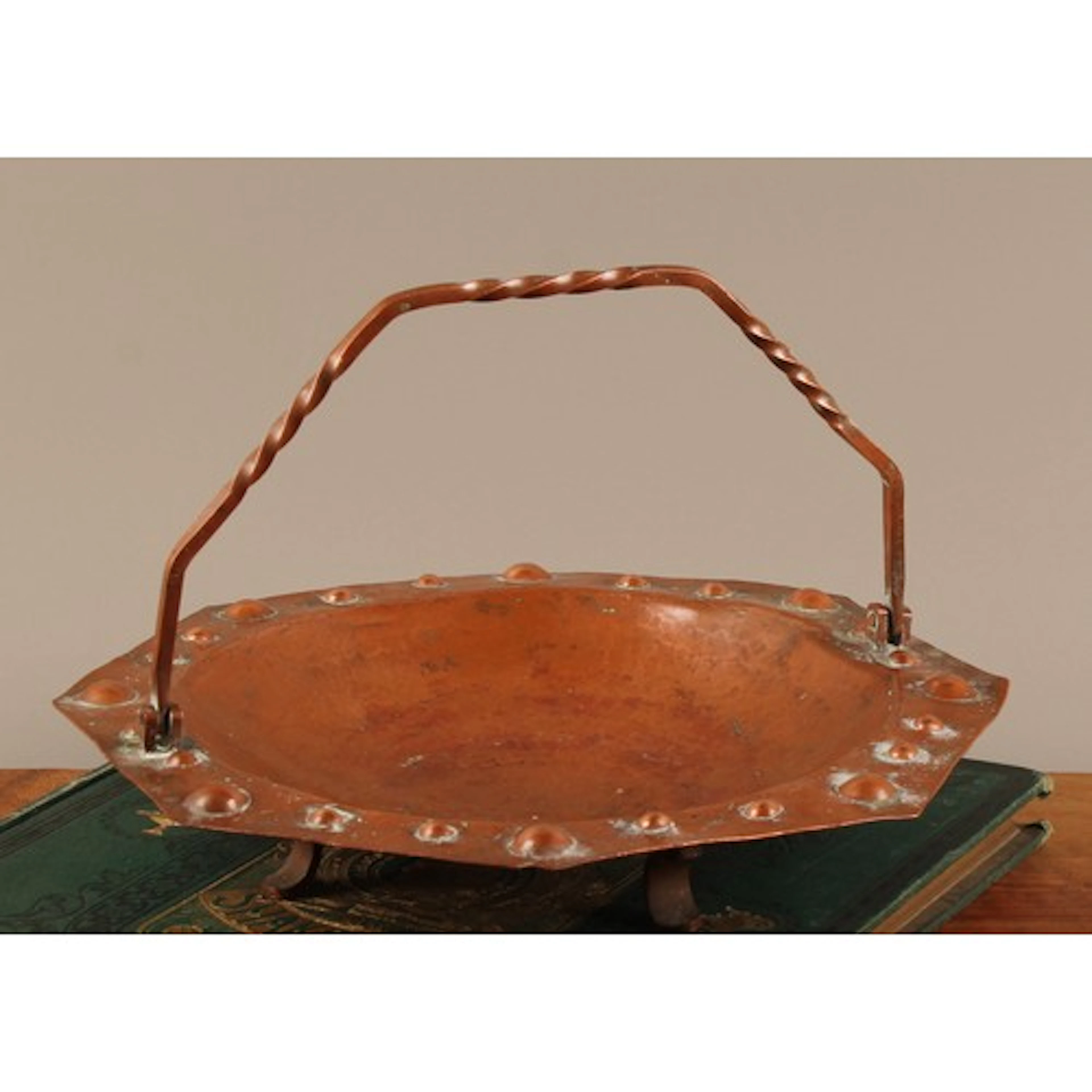 An Arts and Crafts copper octagonal dish, planished overall ...