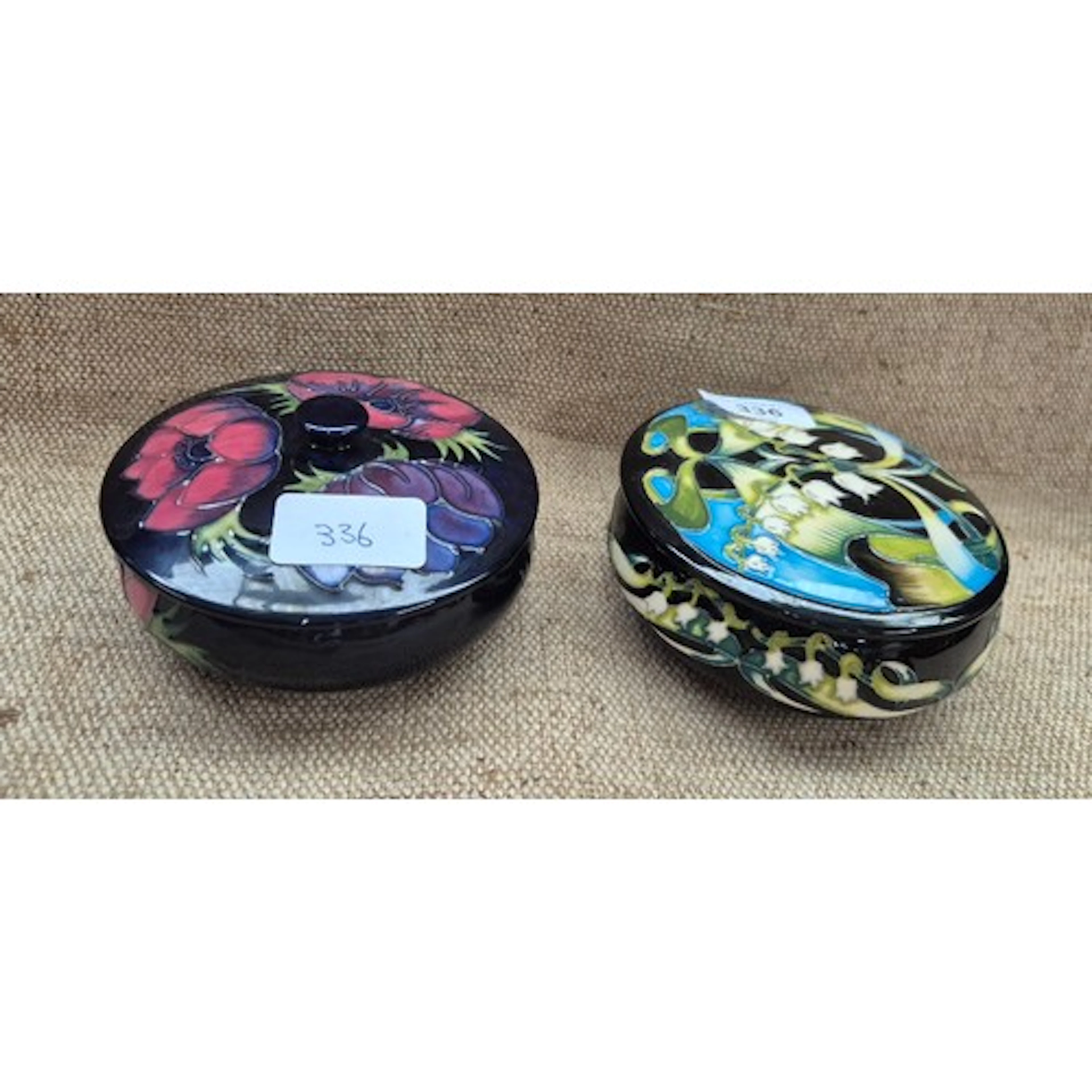2 lidded dishes by Moorcroft. Anemone on dark blue ground, a...