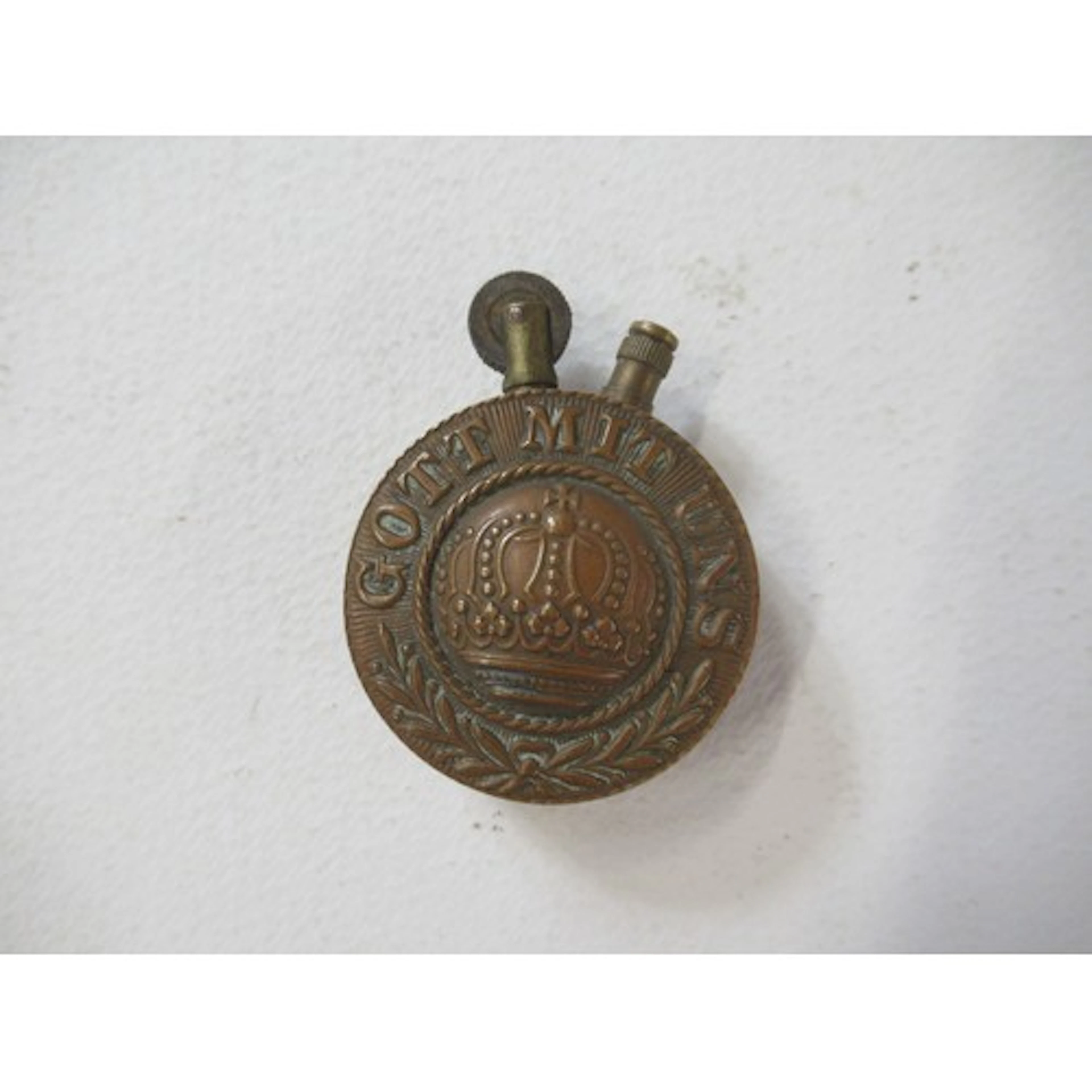 A World War One era Trench art brass pocket lighter, having ...