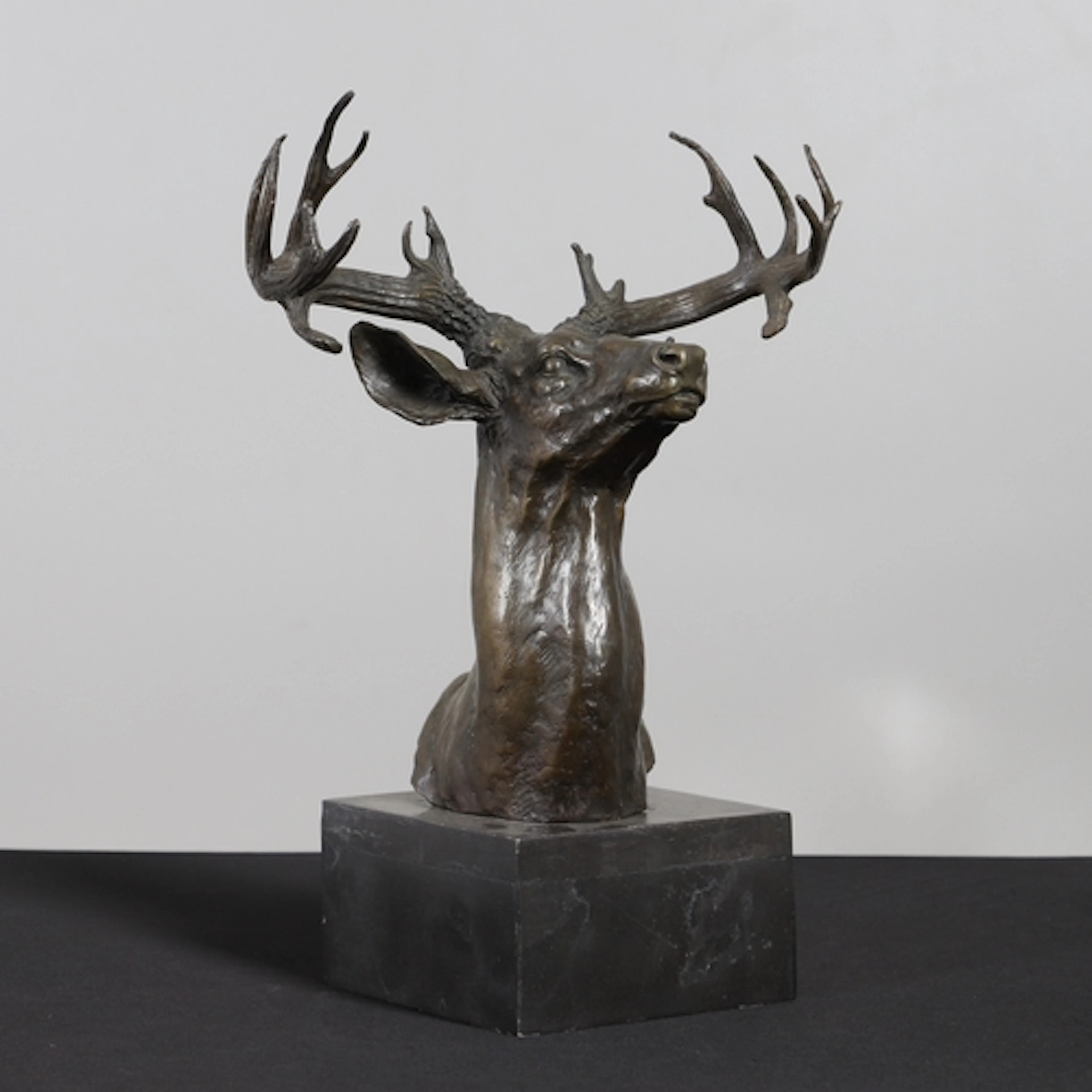A 20TH CENTURY BRONZE OF A STAG'S HEAD. the antler's with 16...