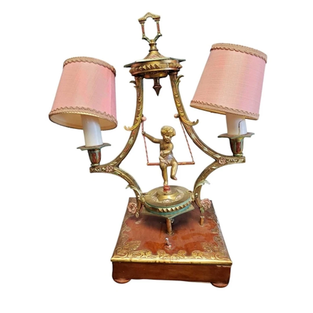 A 1950s twin branch metal cherub table lamp. The central che...